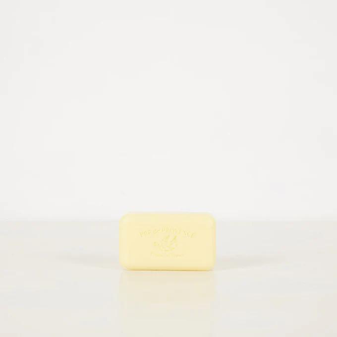 Rectangular light yellow Pré de Provence soap bar. Brand name elegantly embossed on front. Placed on plain white background.