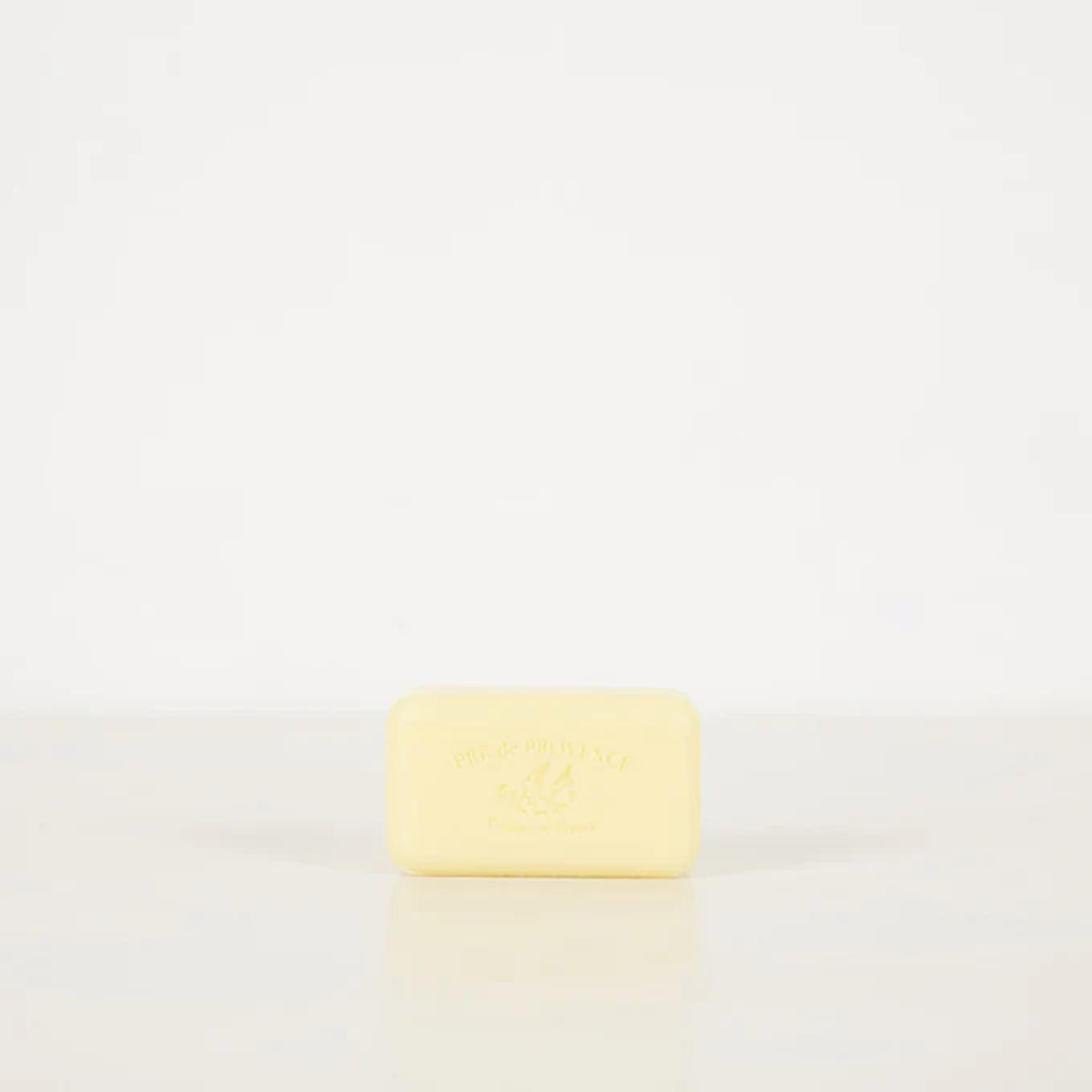 Rectangular light yellow Pré de Provence soap bar. Brand name elegantly embossed on front. Placed on plain white background.
