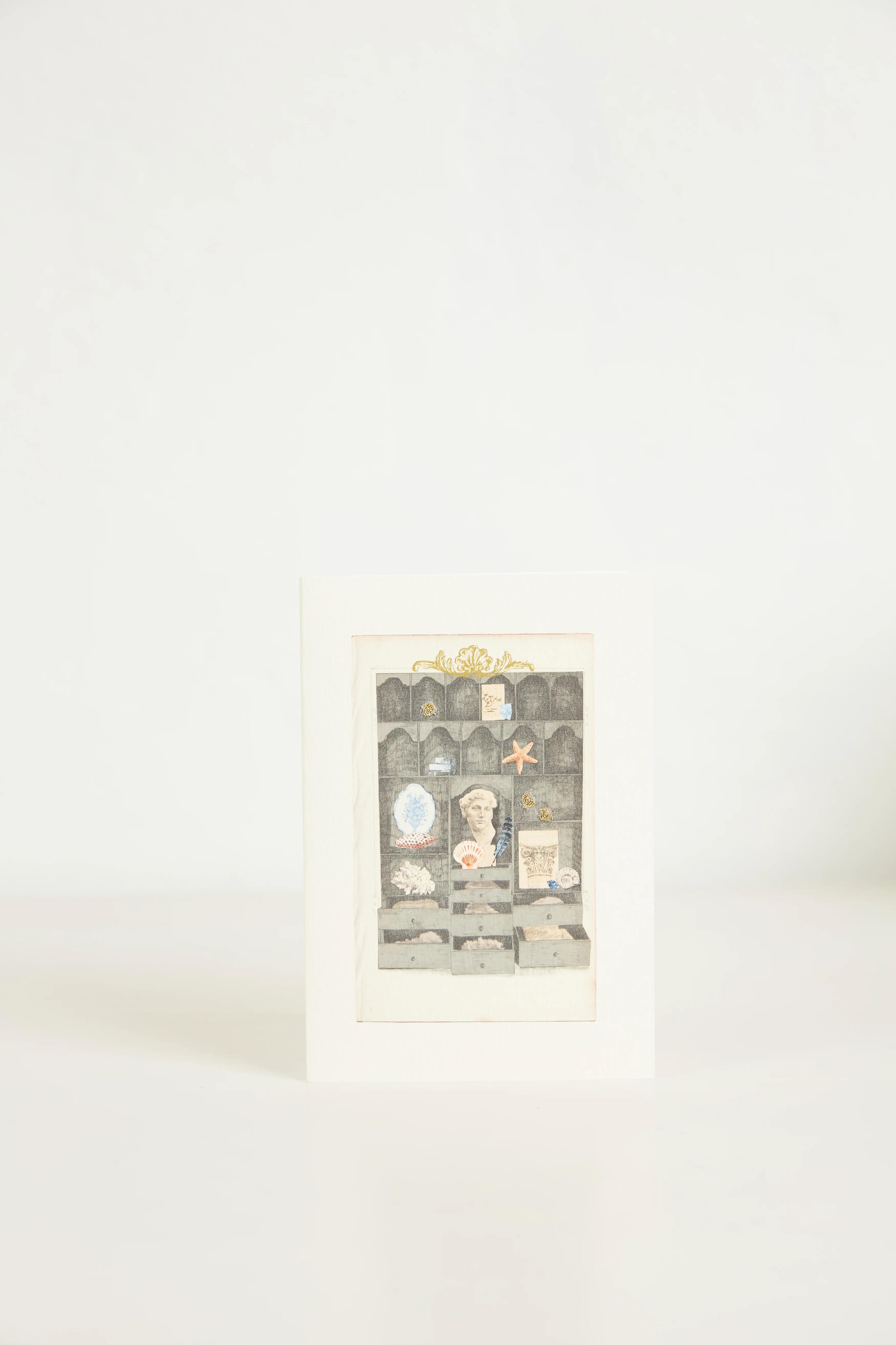 A greeting card with a display cabinet illustration, filled with various small items. The card stands against a plain white background.