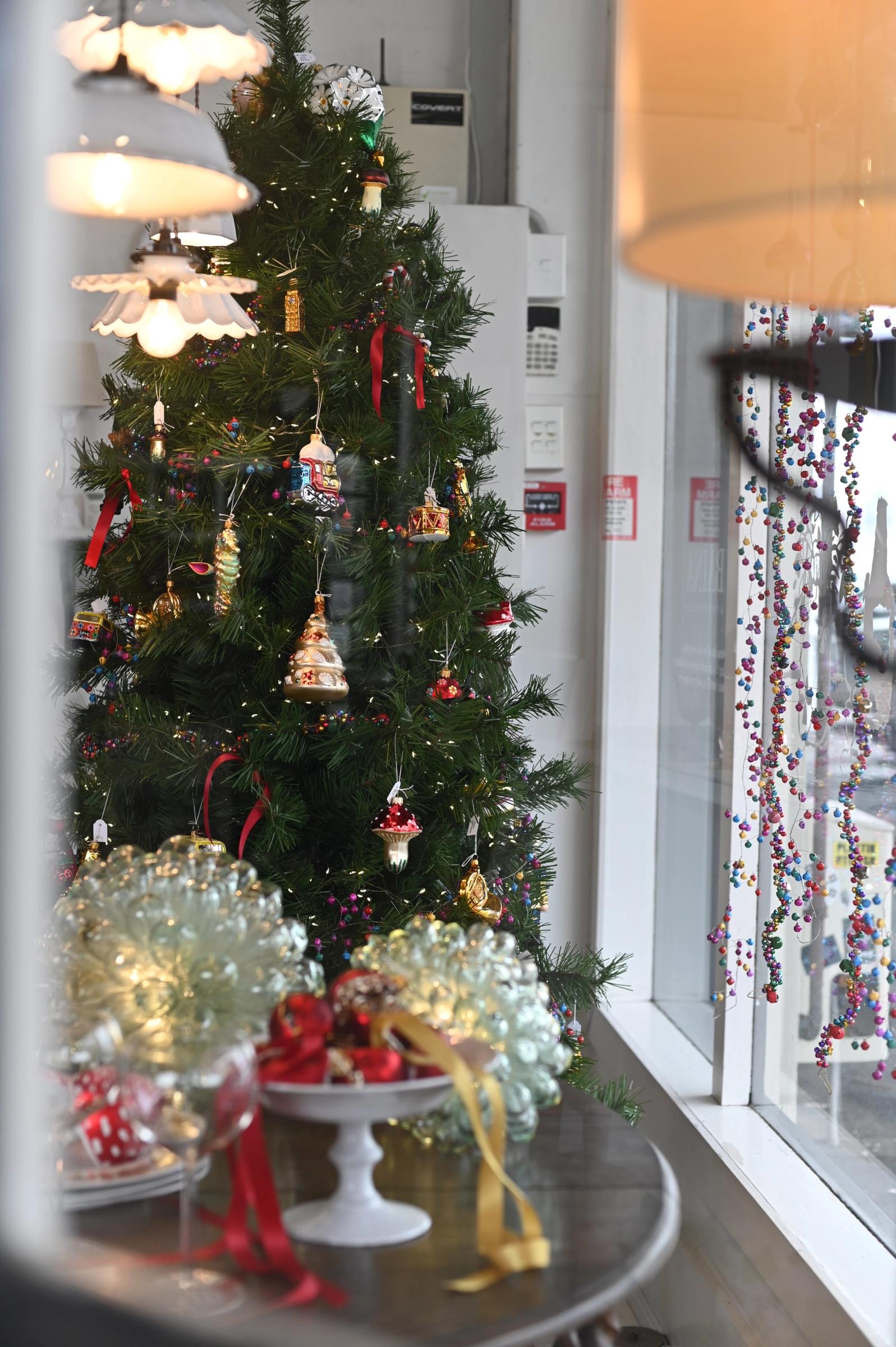 christmas tree and garlands in the store window front