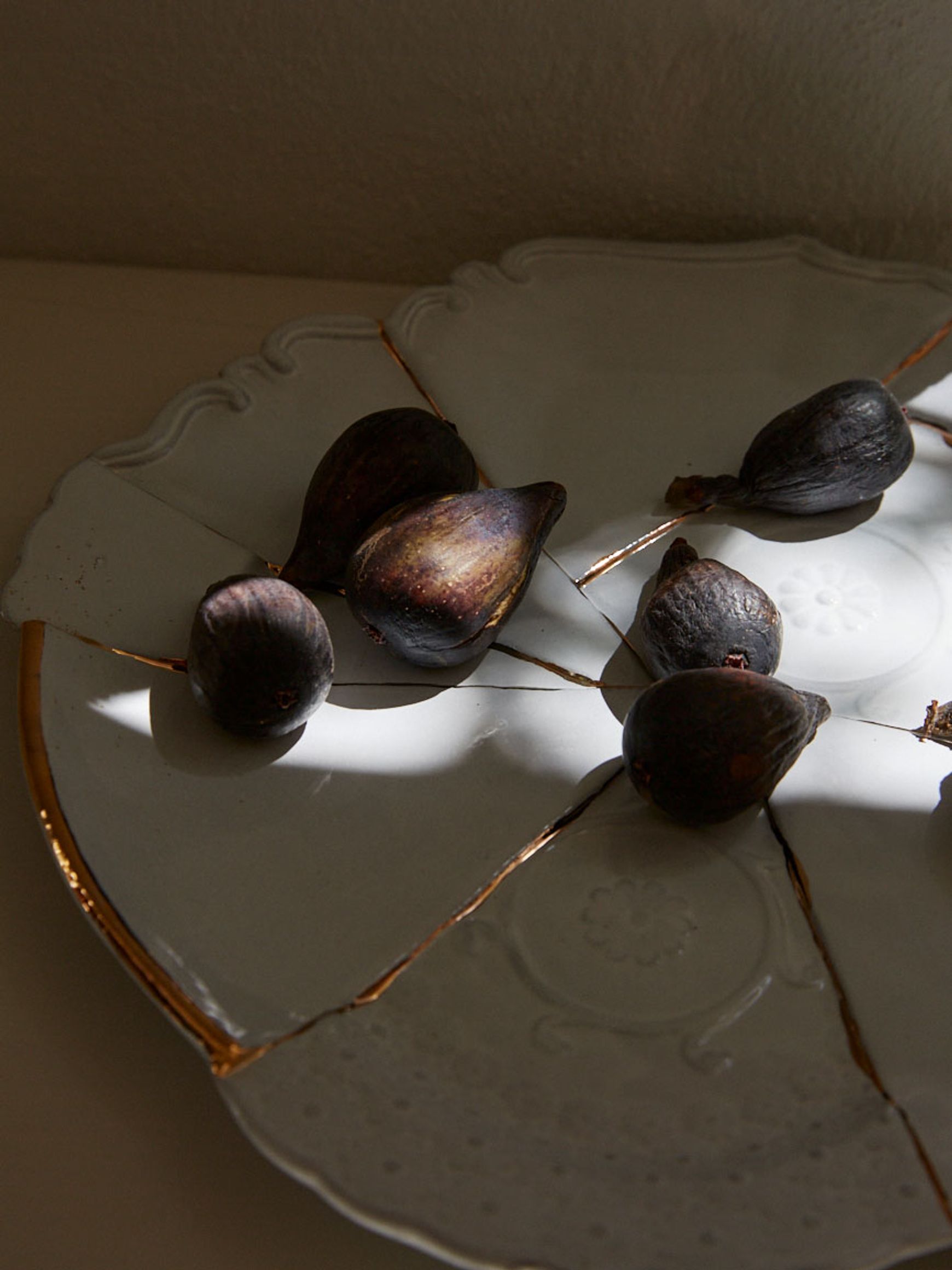 one large plate with gold accent with fresh purple figs