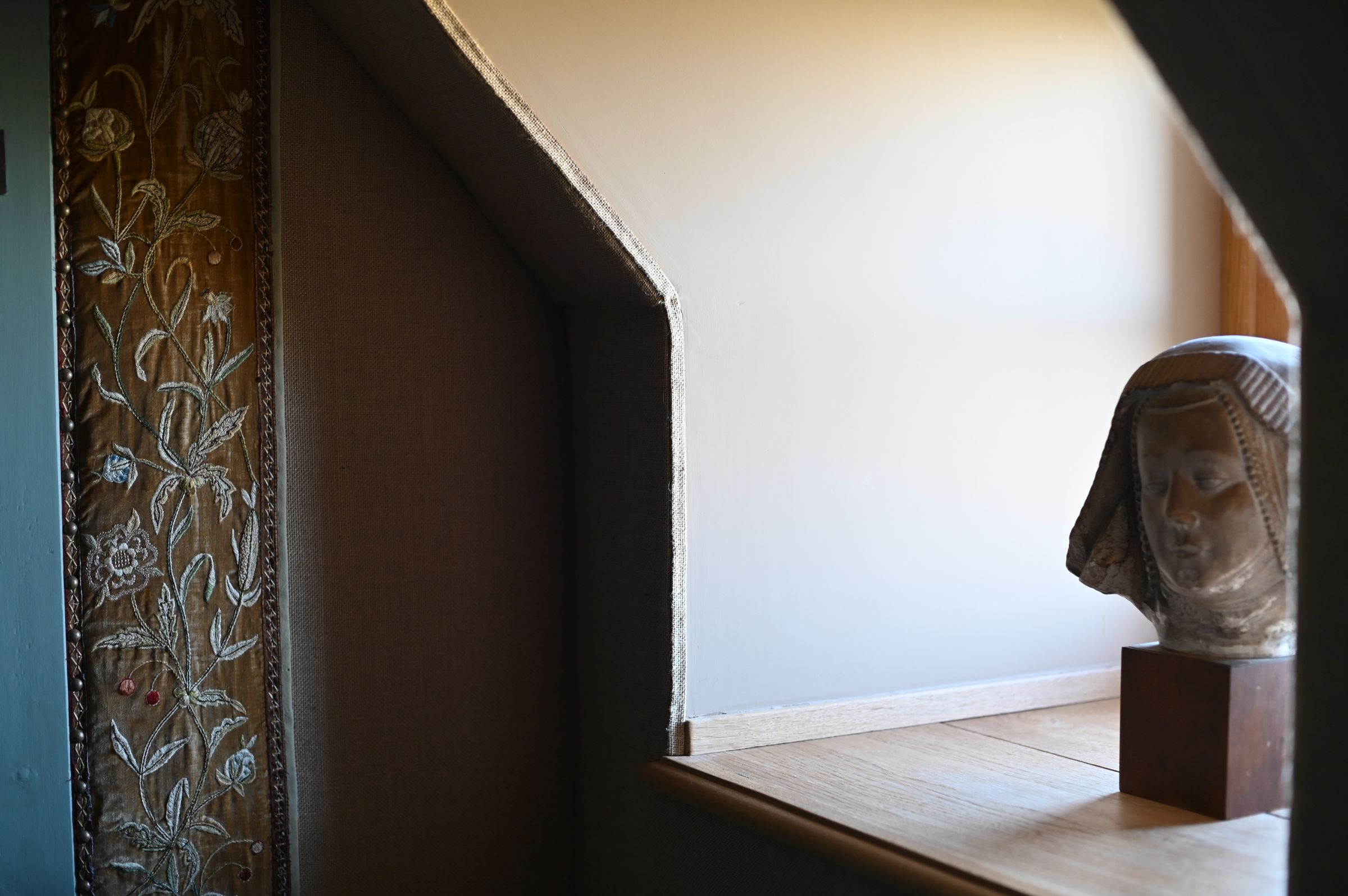 a window trimmed in fabric and a stone head