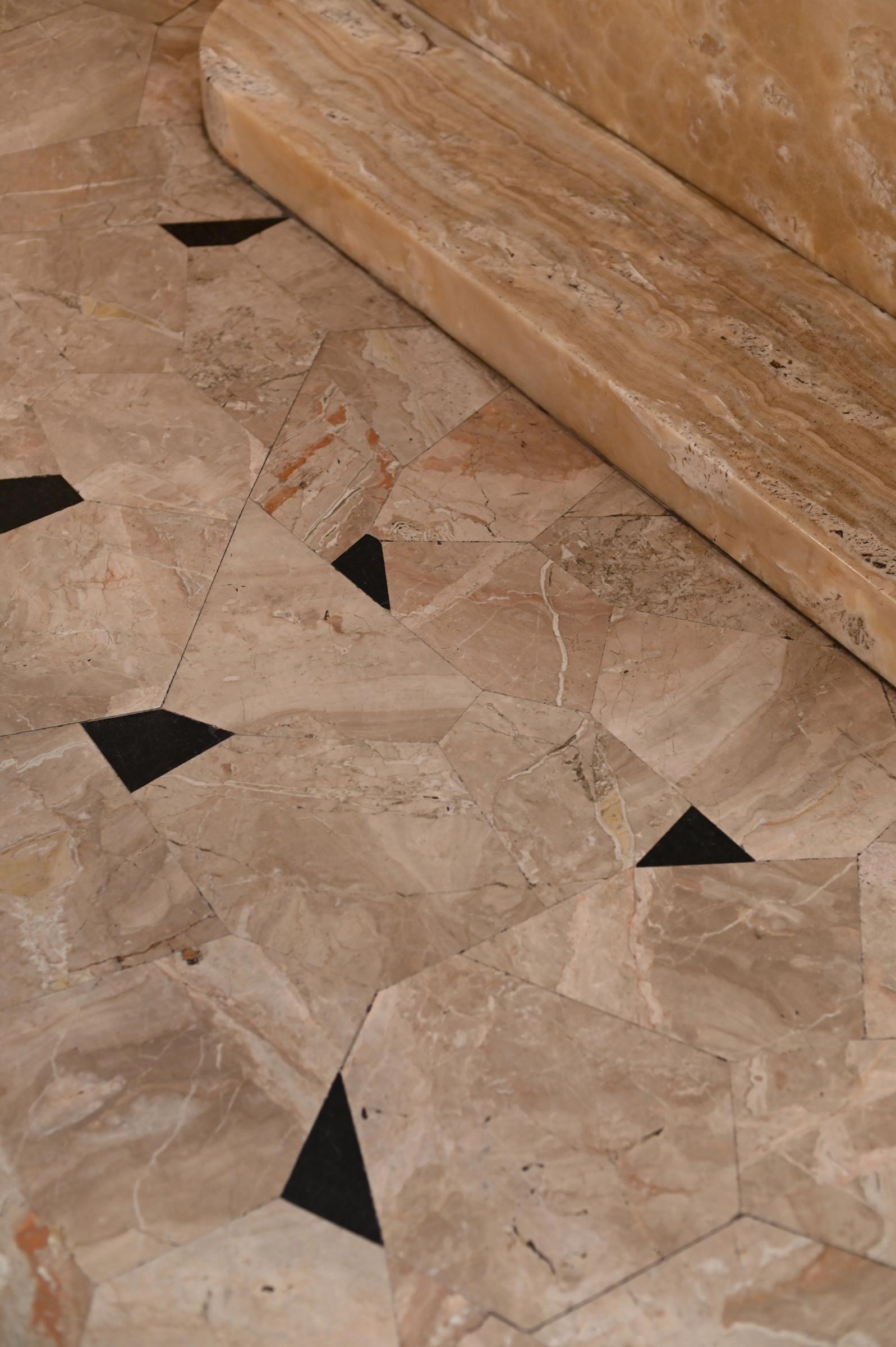 a detail of the marble flooring with black speckles