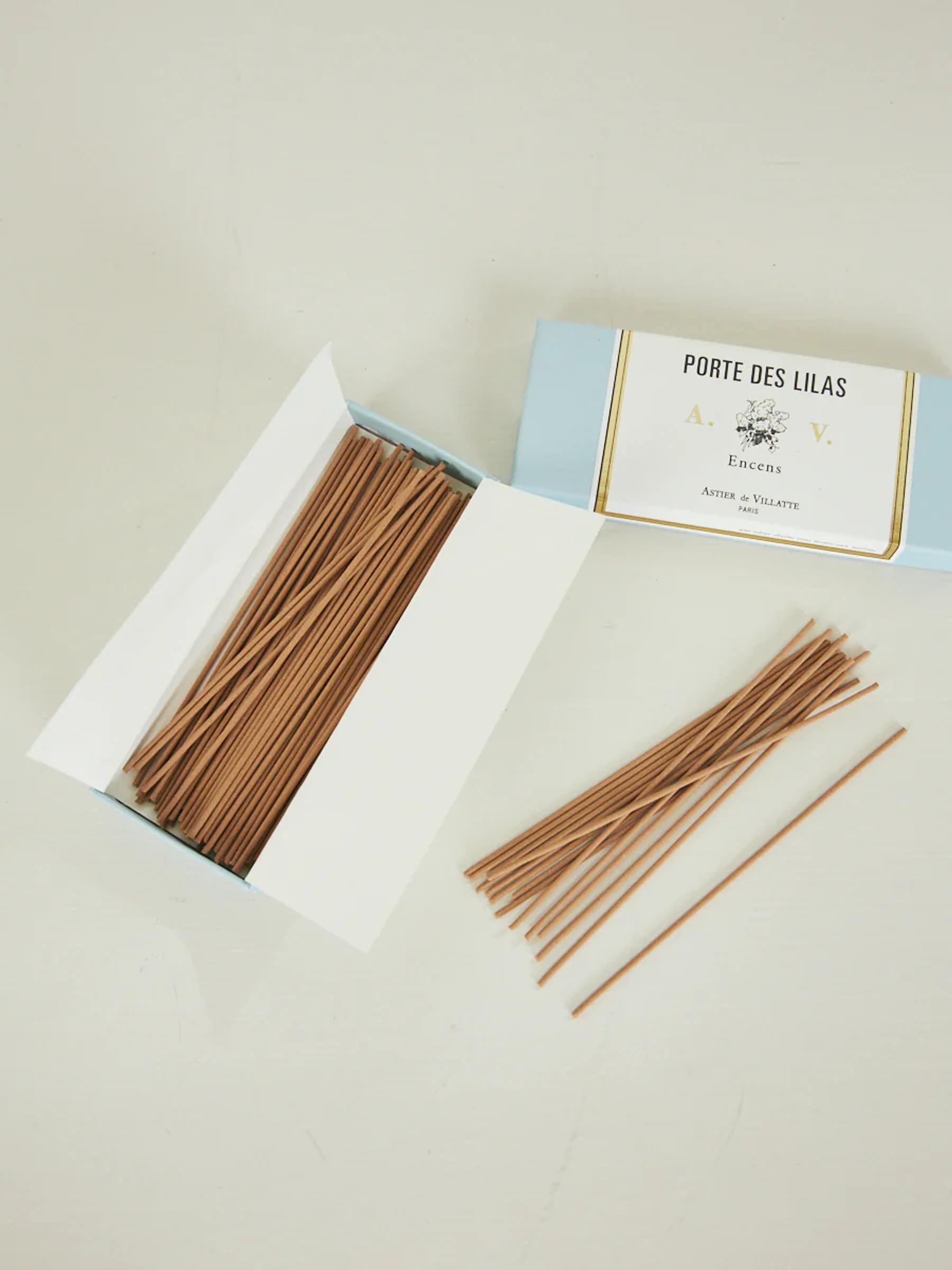 Light blue "Porte des Lilas" box with brown incense sticks. Some sticks laid out nearby.