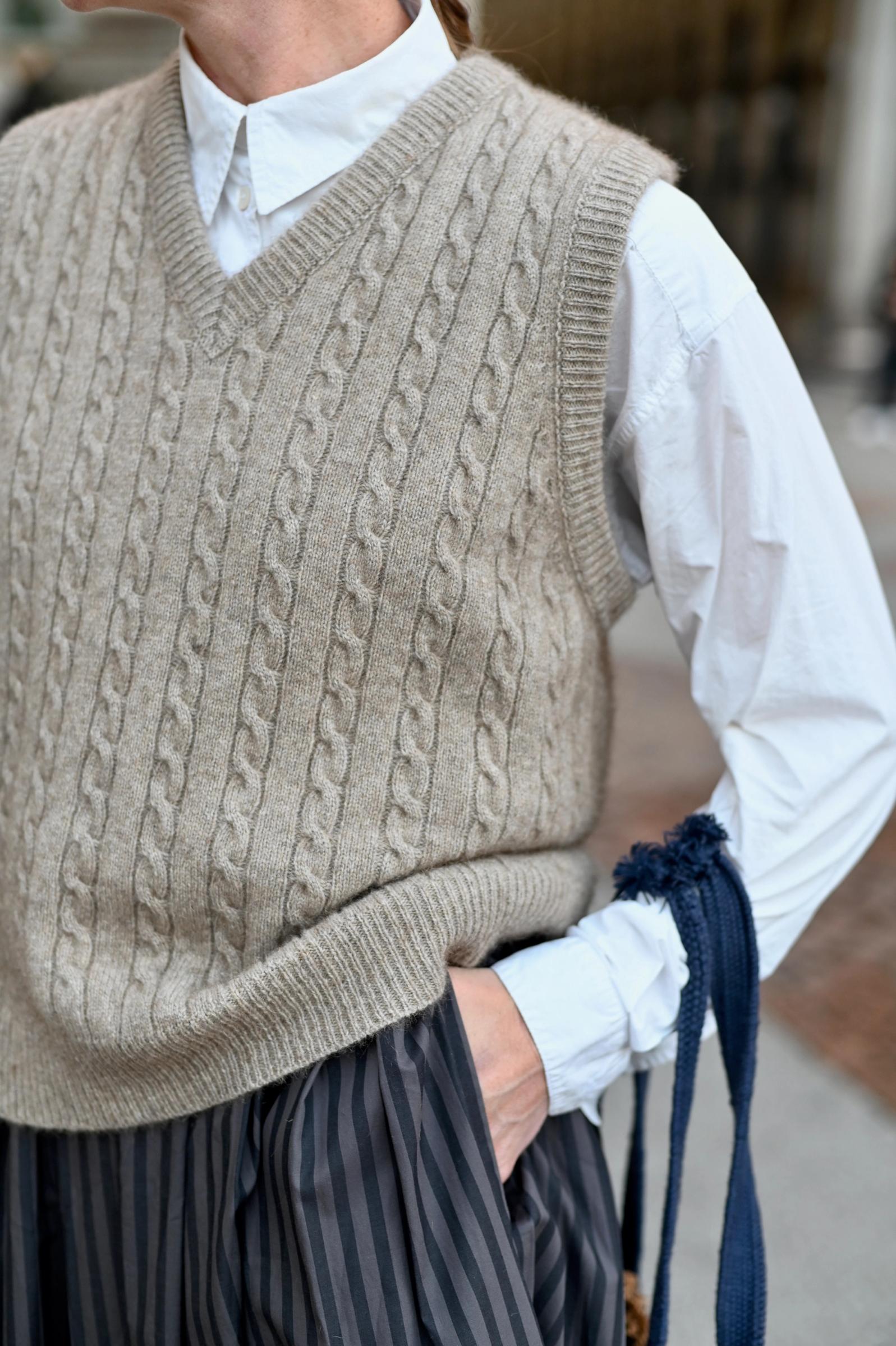 close up image of cable knit vest in merino wool