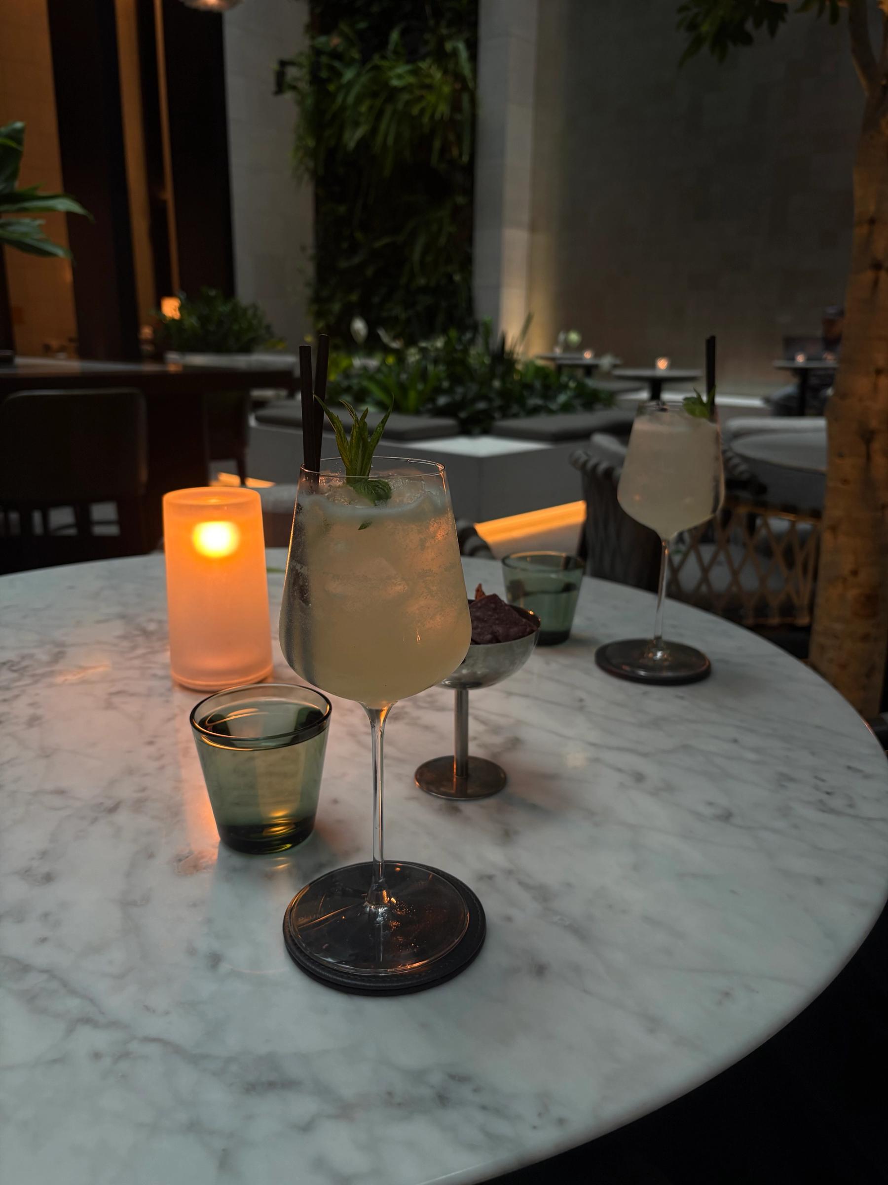 two glasses on a marble table in candlelight