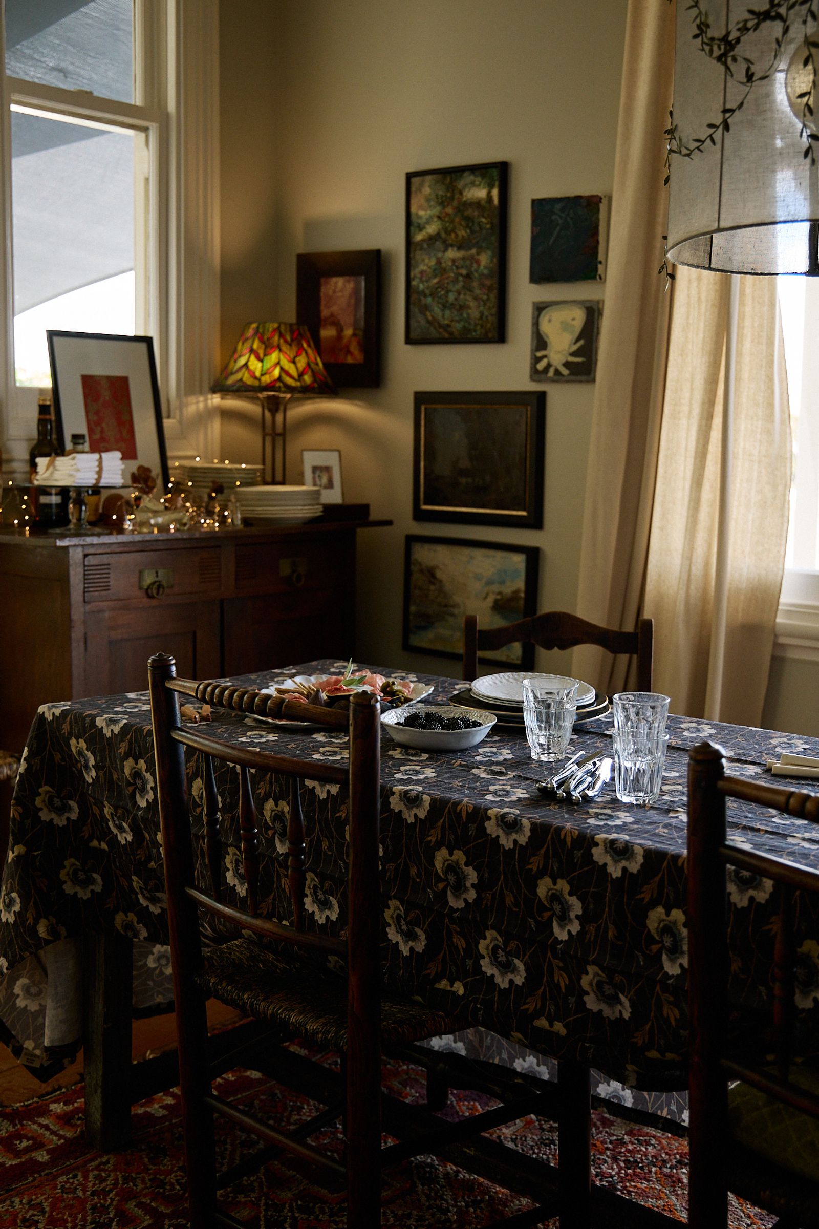 dining room with warm lamps and dark tablecloth 