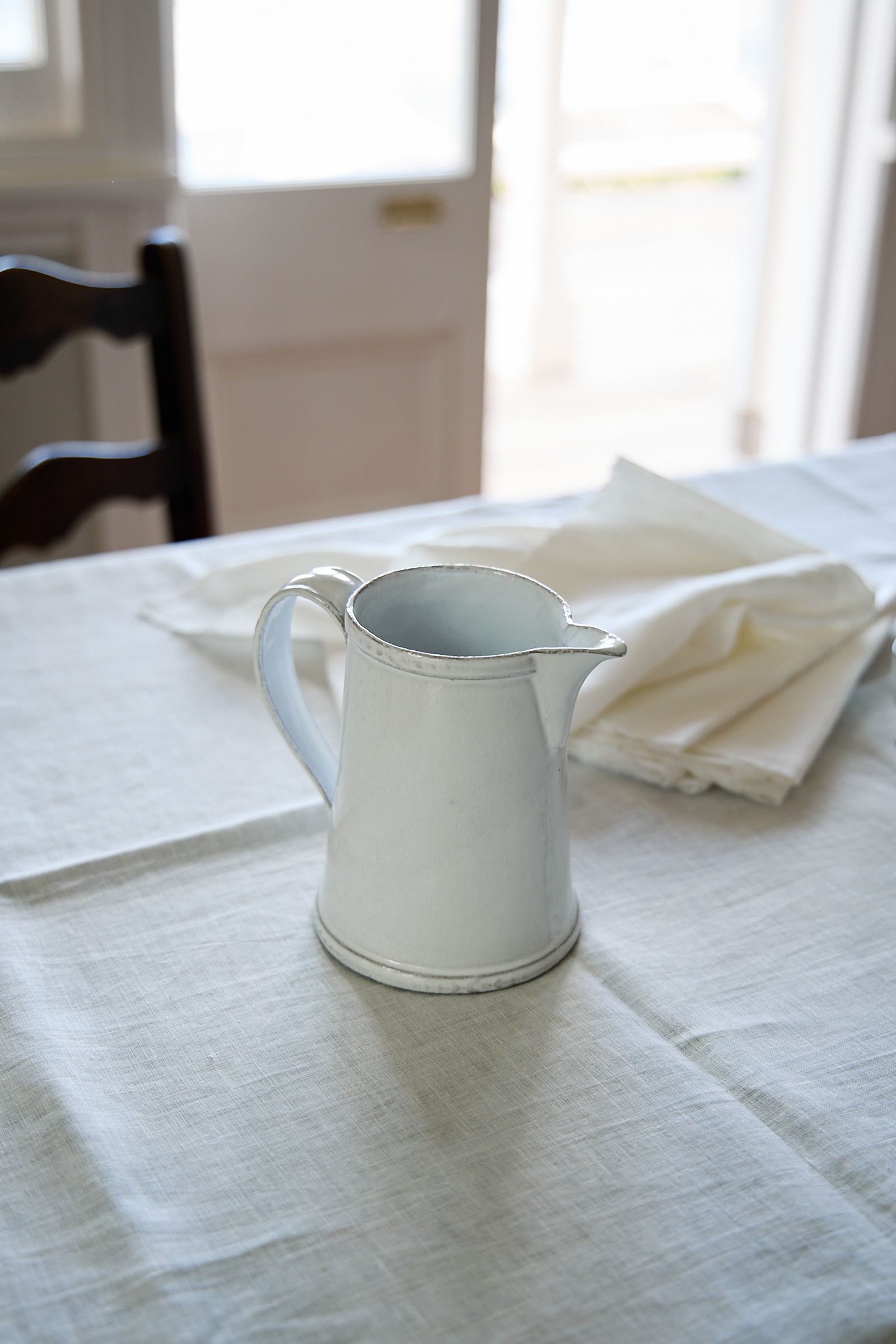 white pitcher jug on a white table cloth in natural light