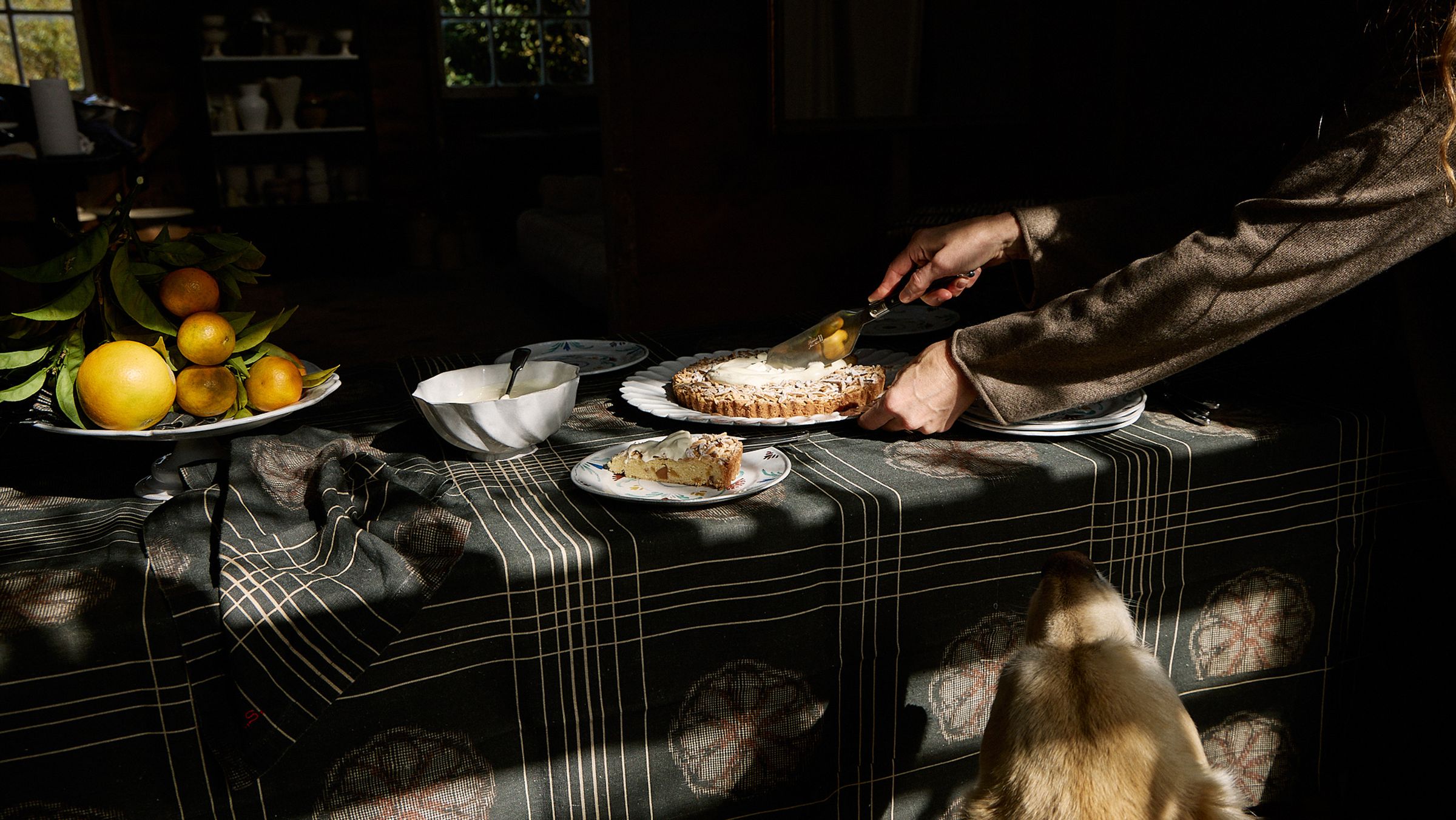 Dining table with dark linen cloth, serving homemade tart