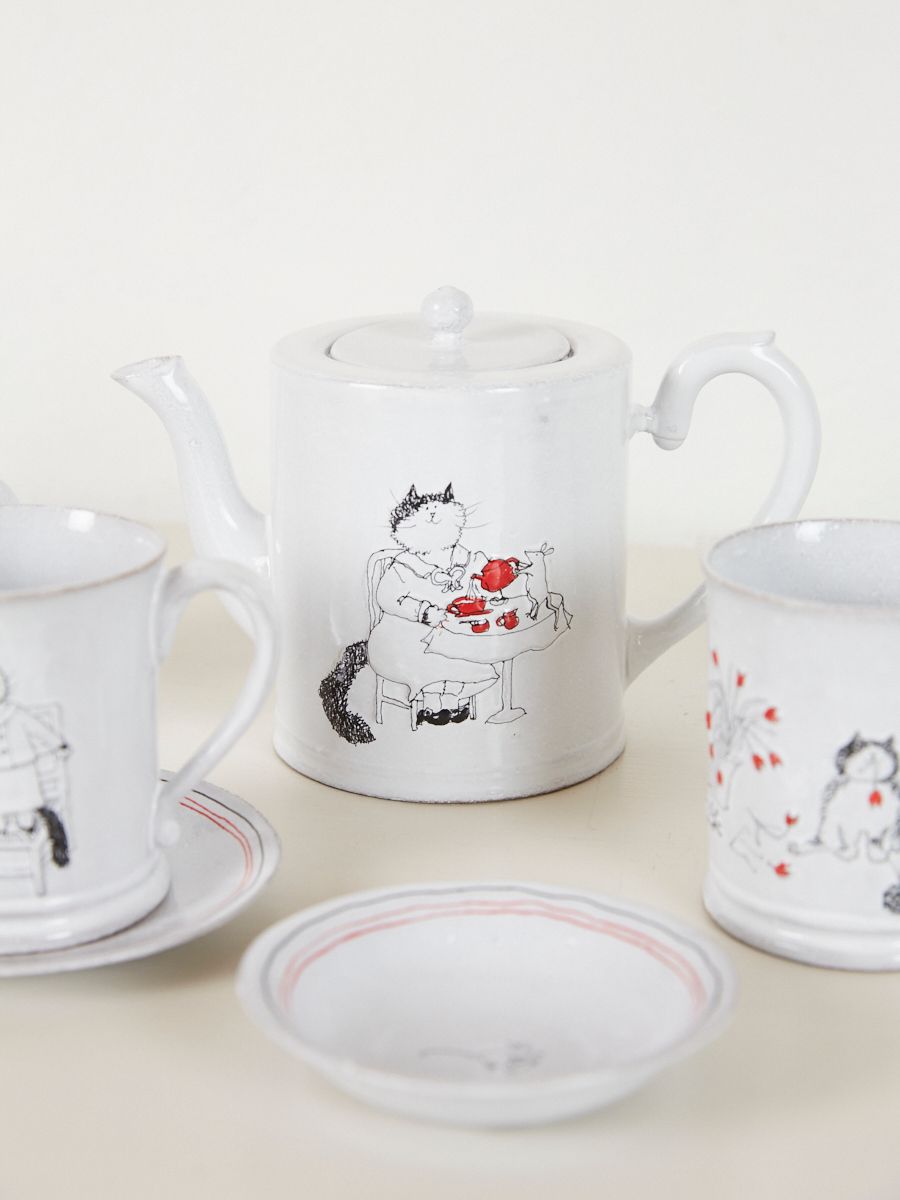 Ceramic teapot with an illustration of a mother cat sitting at a table for tea 