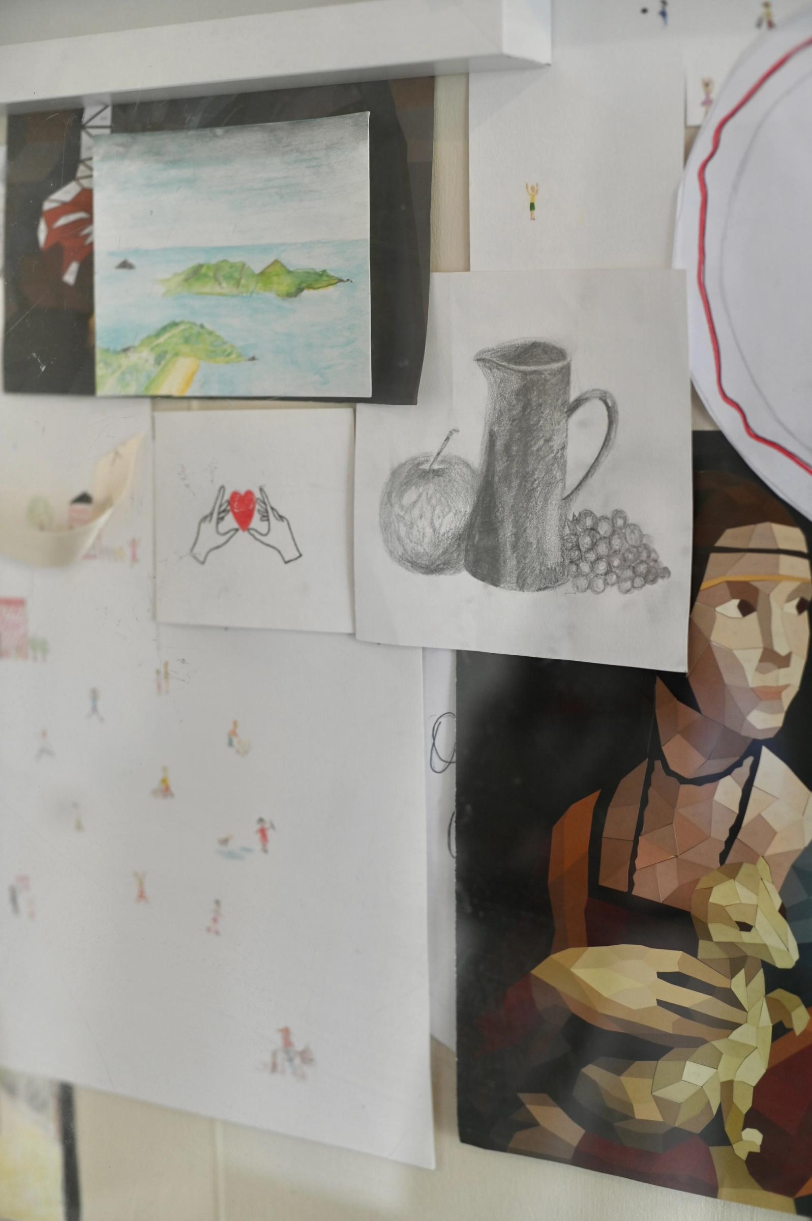 more hand drawings hanging on studio wall