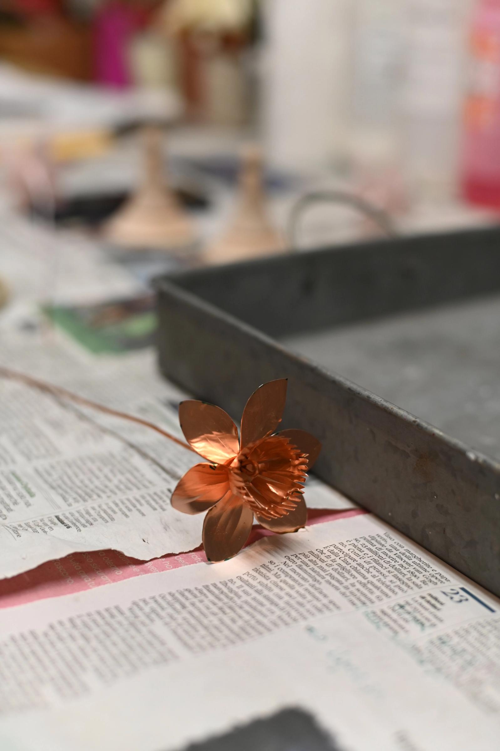 close up of copper flower ready to be painted