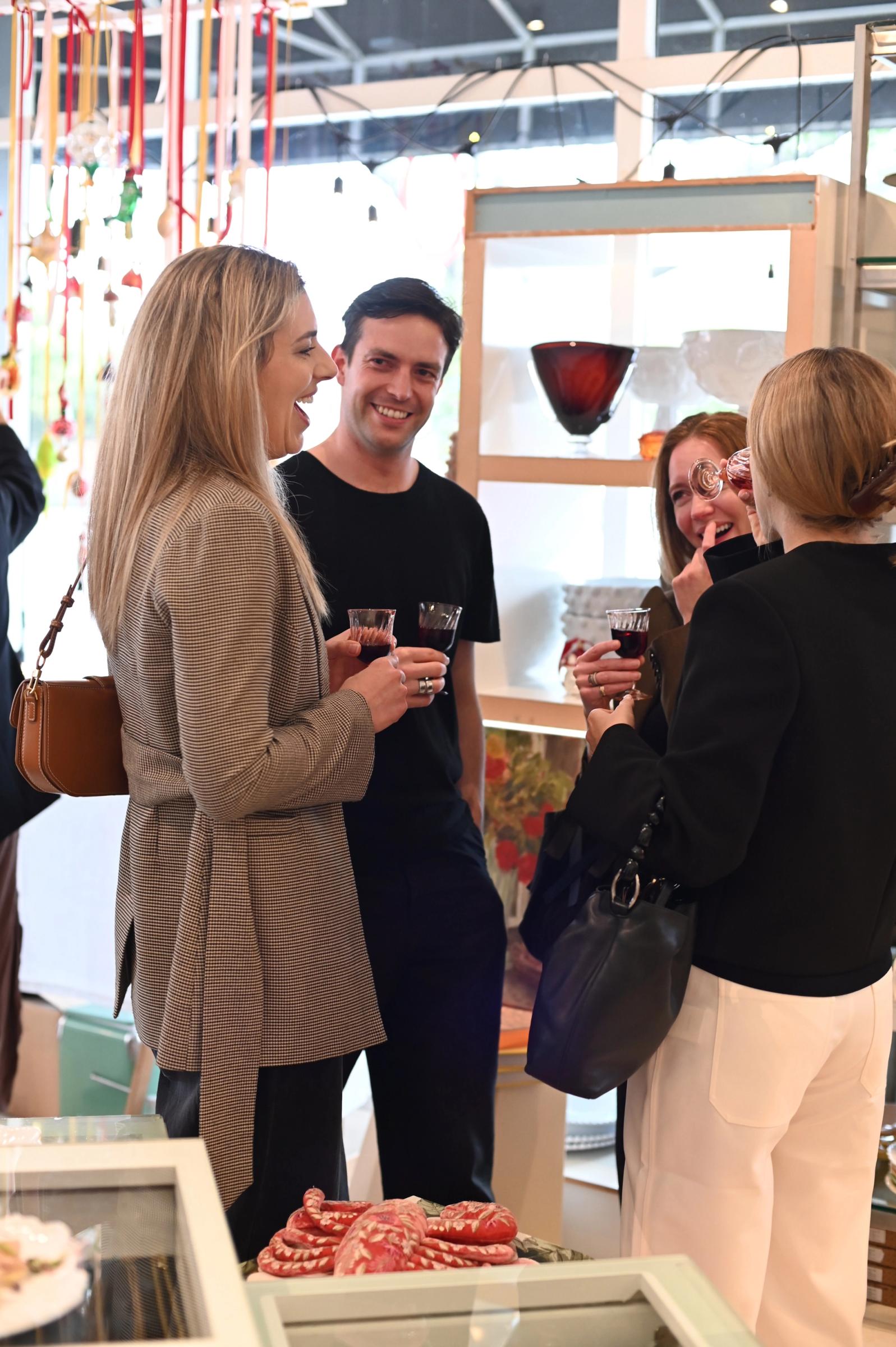guests enjoy a catch up and a wine in store