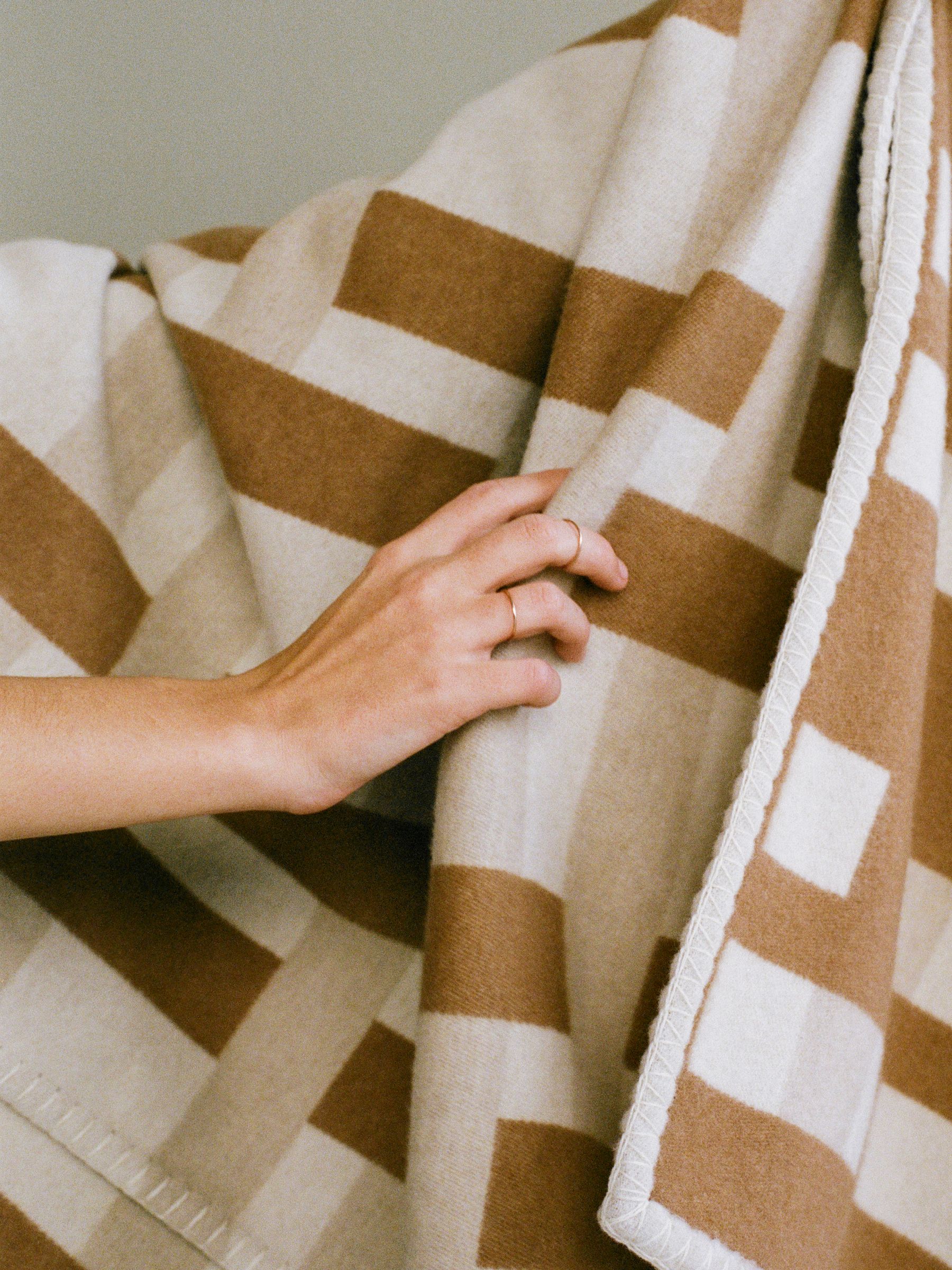 Close up of wool/cashmere jacquard throw in beige tones