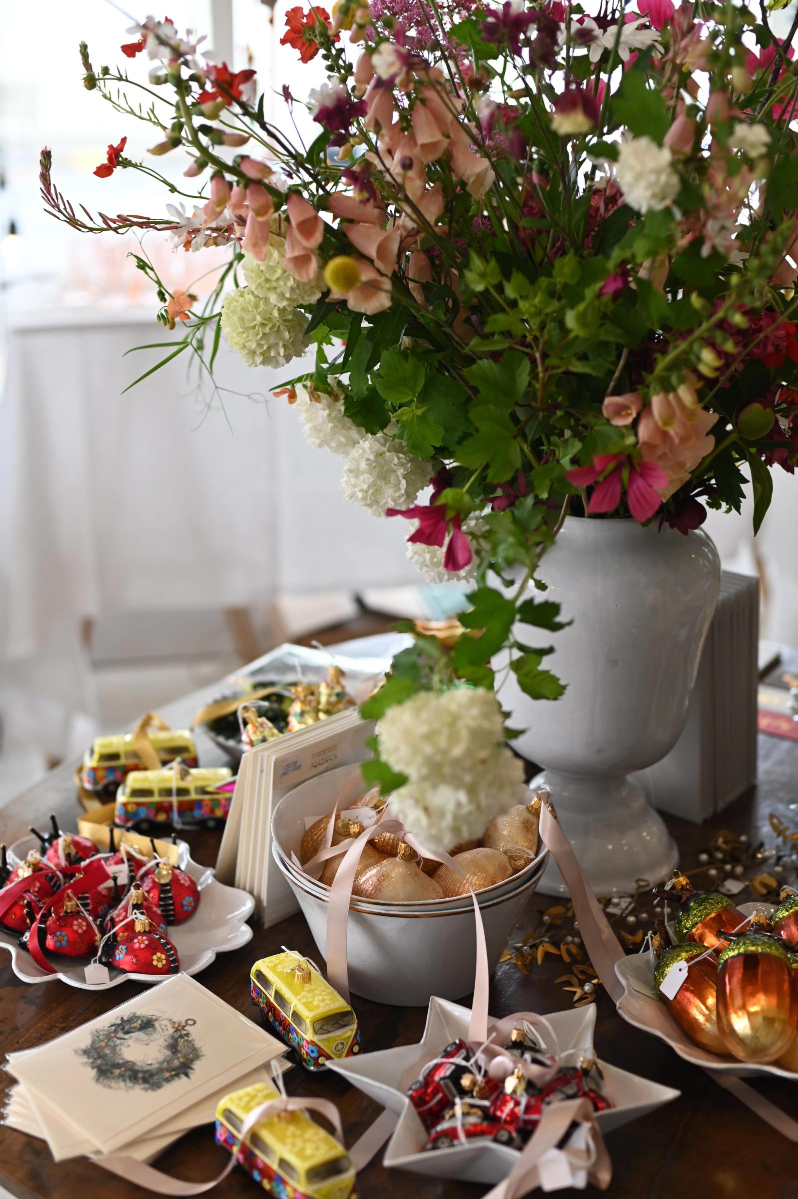 vase filled with flowers surrounded by cards, ribbon and decorations