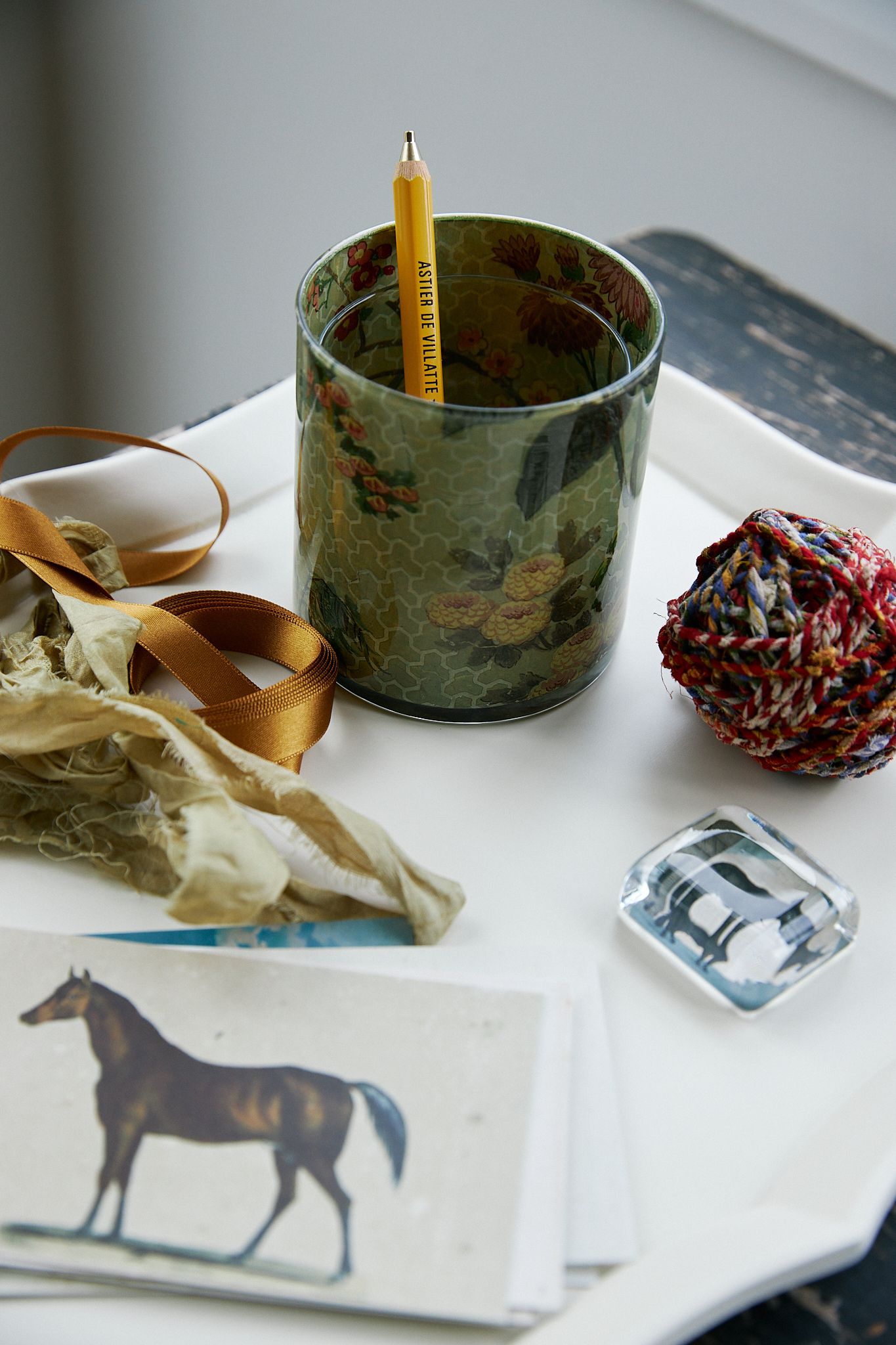 Tray filled with string postcards and a paperweight