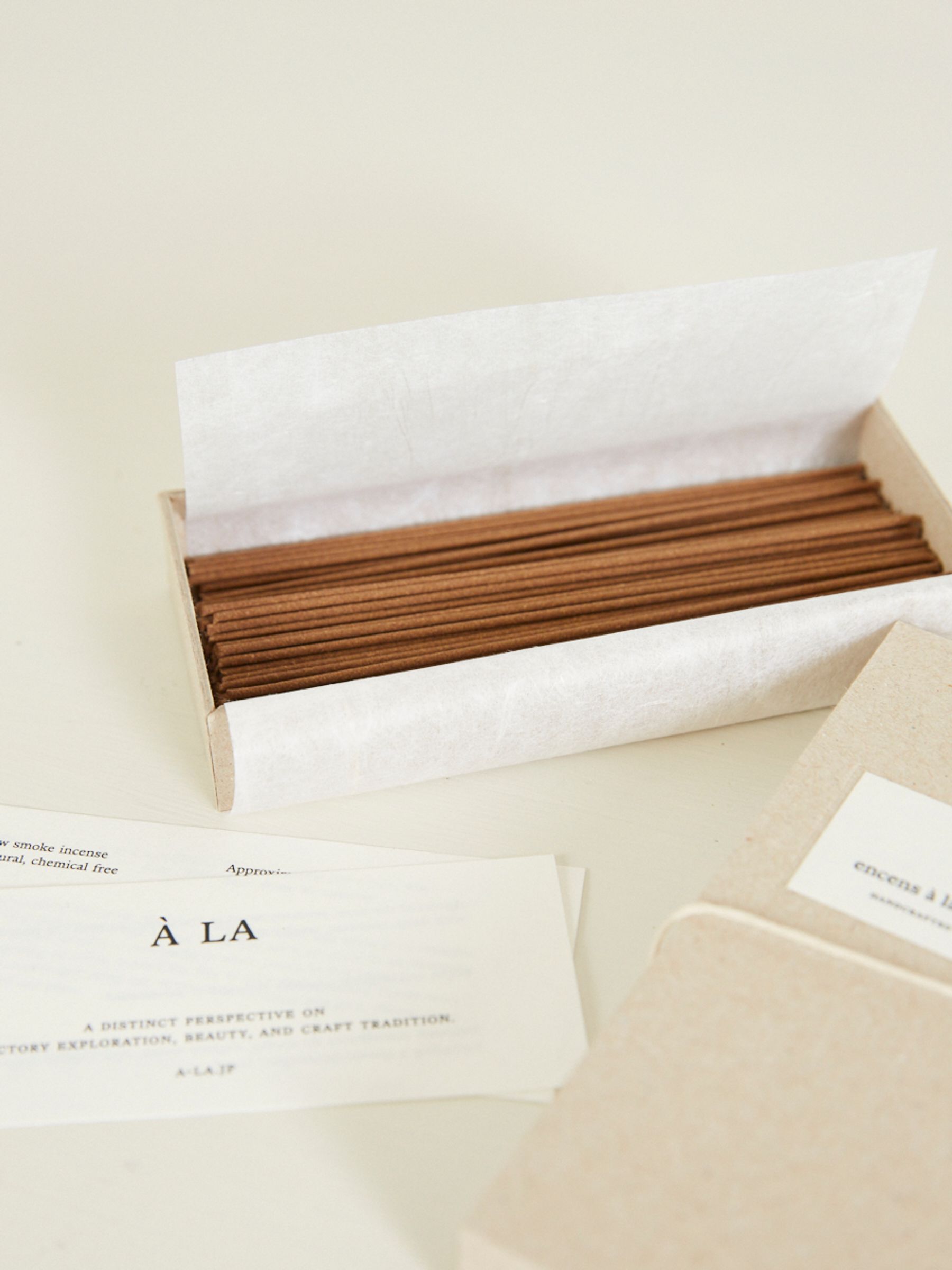 close up of incense box open with incense sticks and paper 