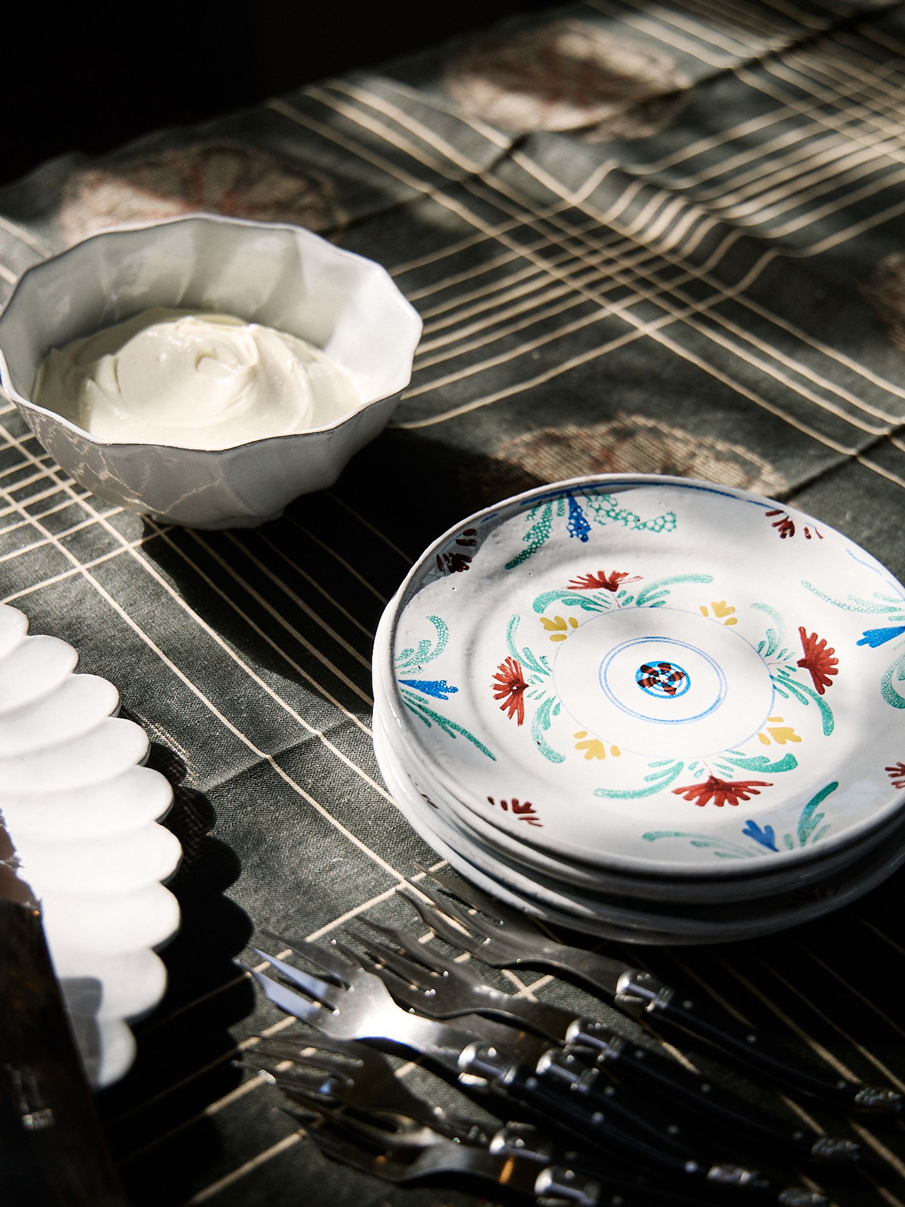 four bright hand painted plates
