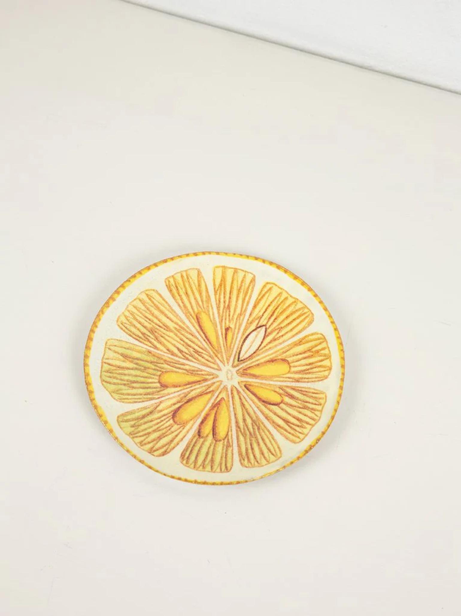 Artistic citrus slice coaster on white surface. Detailed yellow and orange segments evoke summer drinks and celebrations.