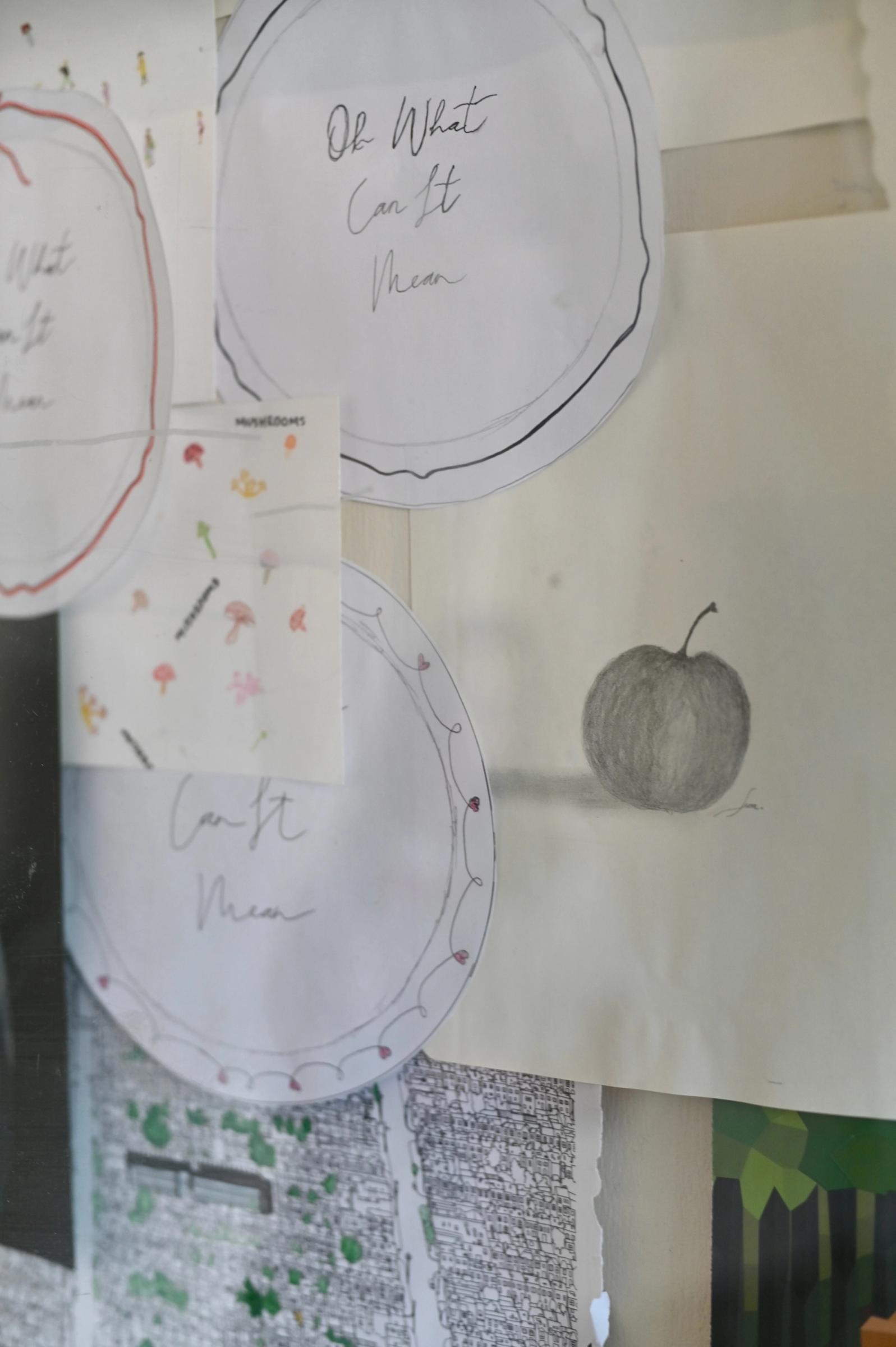 close up of artist drawings hanging on studio wall