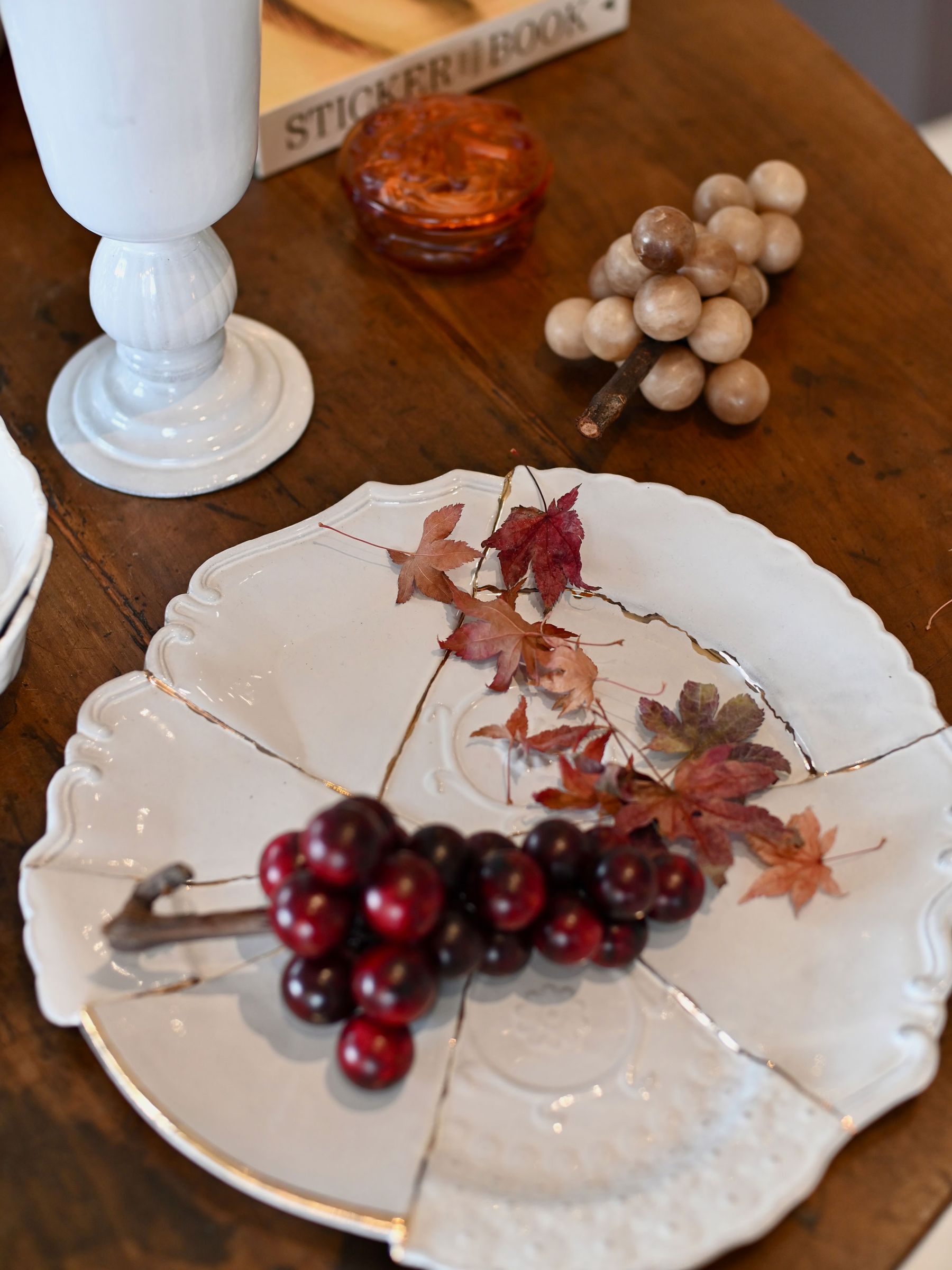 Purple Italian Marble Grapes on ceramic dish with Autumn leaves
