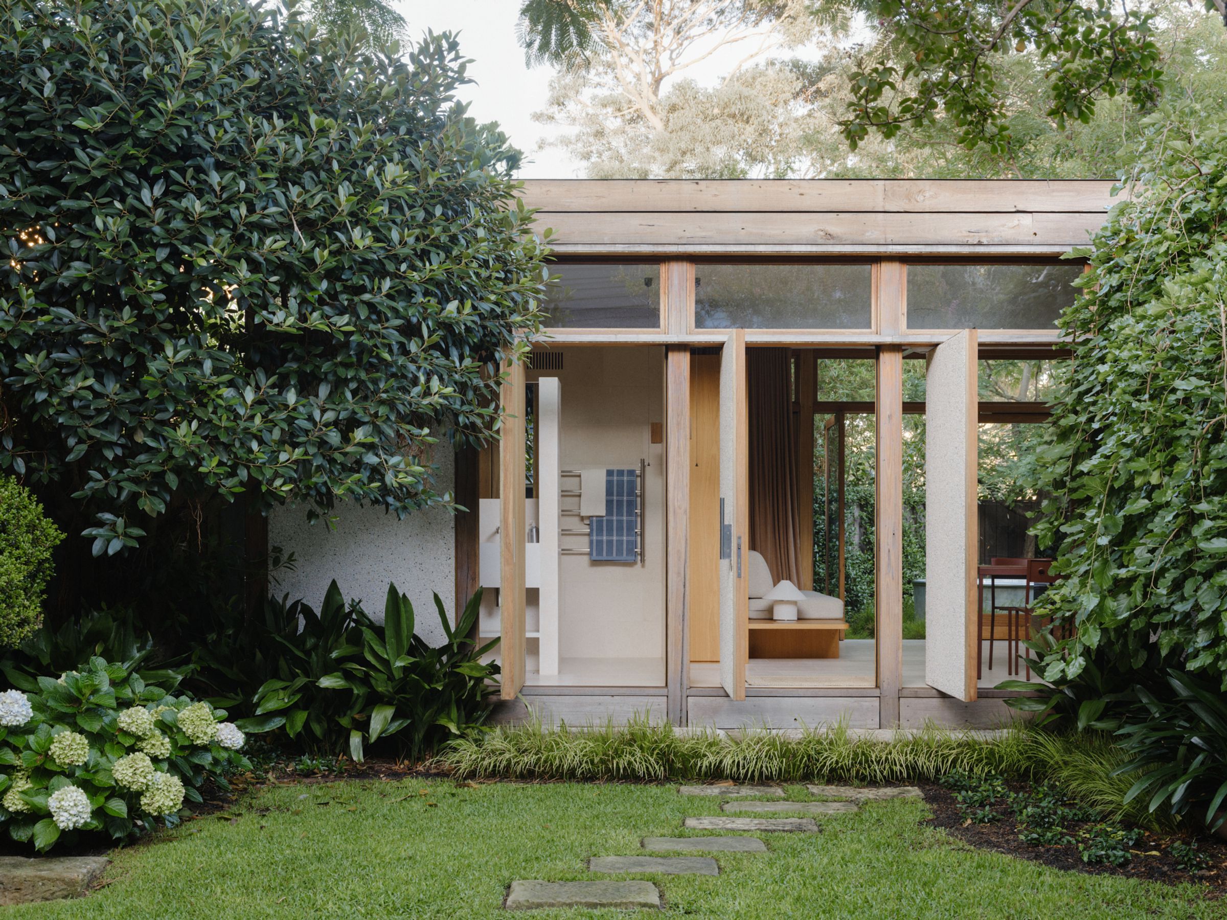 a wide shot of the wooden retreat and spa that shows Baina towels 
