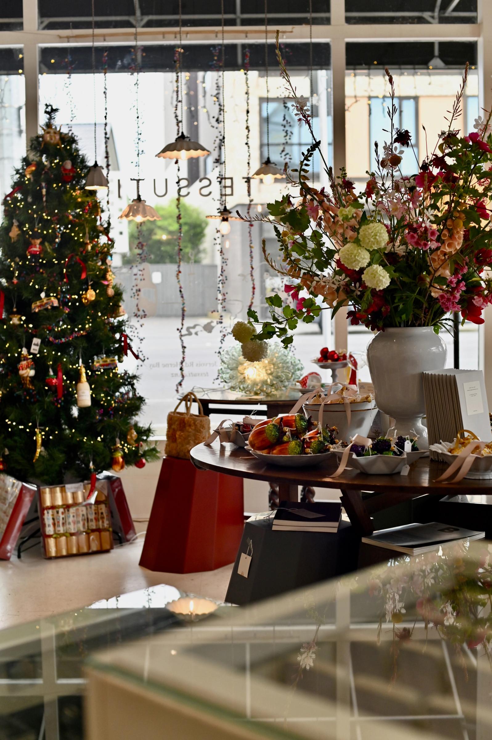 a christmas tree is decorated in the store window