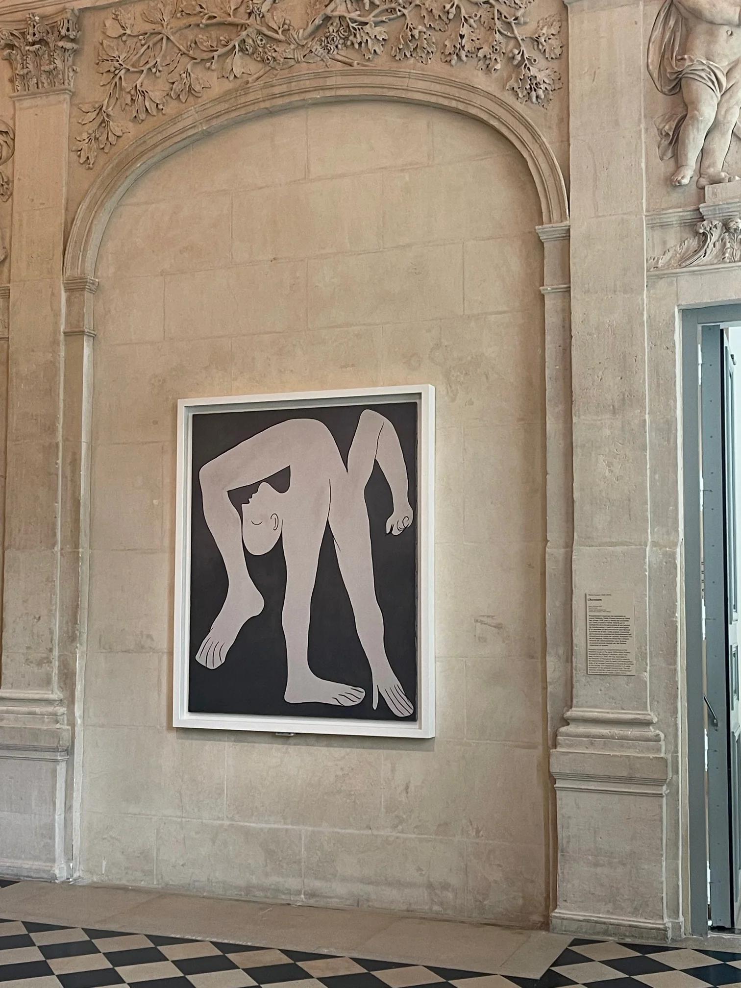 Framed abstract painting of contorted figure on textured stone wall. Classical architectural style, open doorway to right.