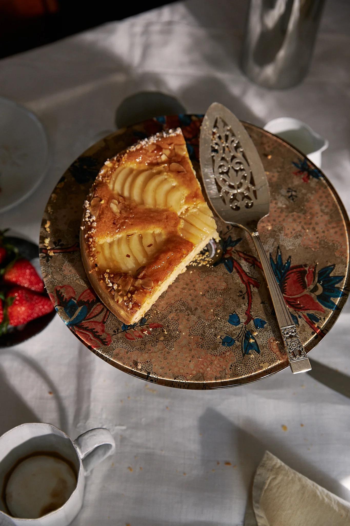 Bird's eye view of the pear tart sitting on top of the glass cake stand