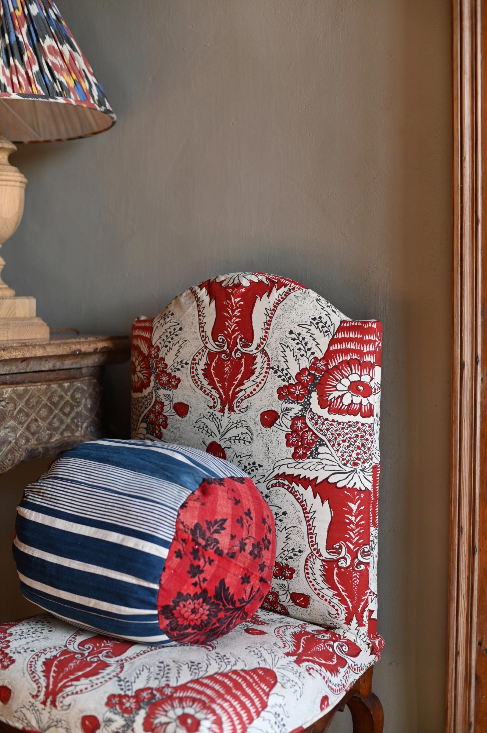 a fabric covered chair with a textile cushion in two fabrics