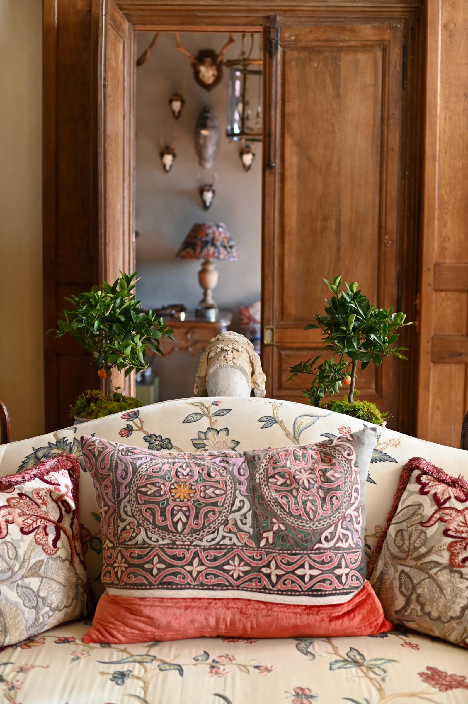 focus on an antique embroidered cushion in the sitting room