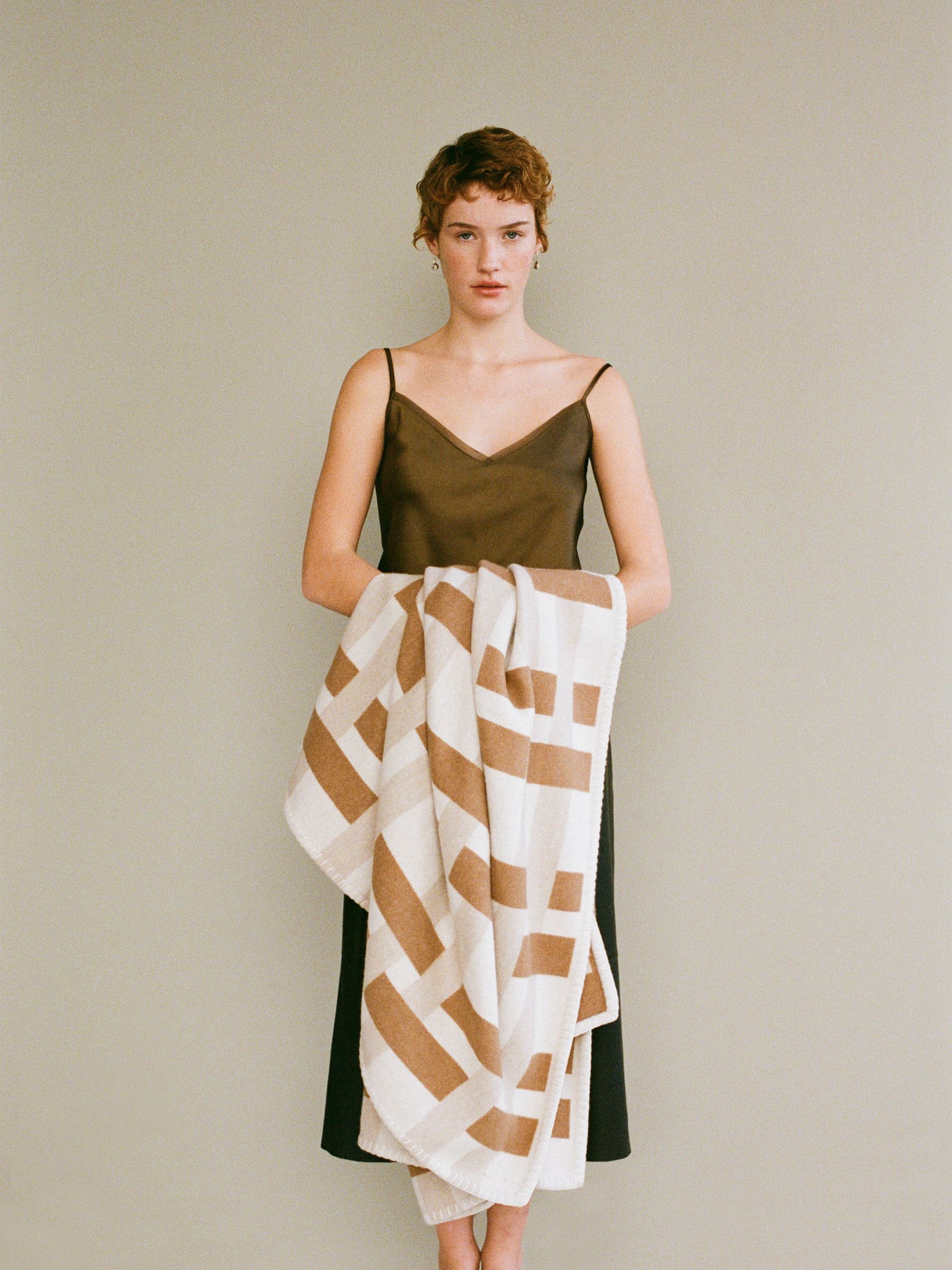 Woman holding wool and cashmere throw