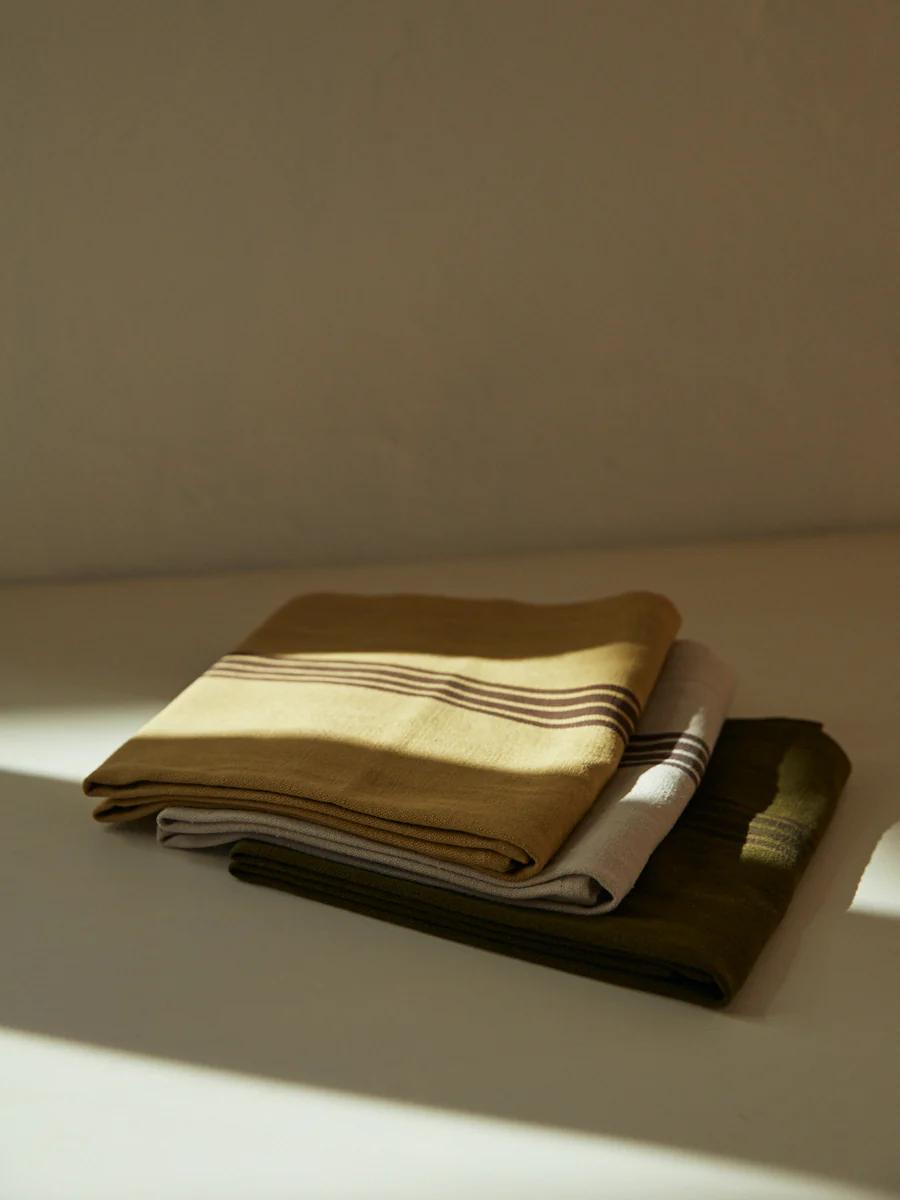 Stack of folded towels evoking cozy, simple charm.