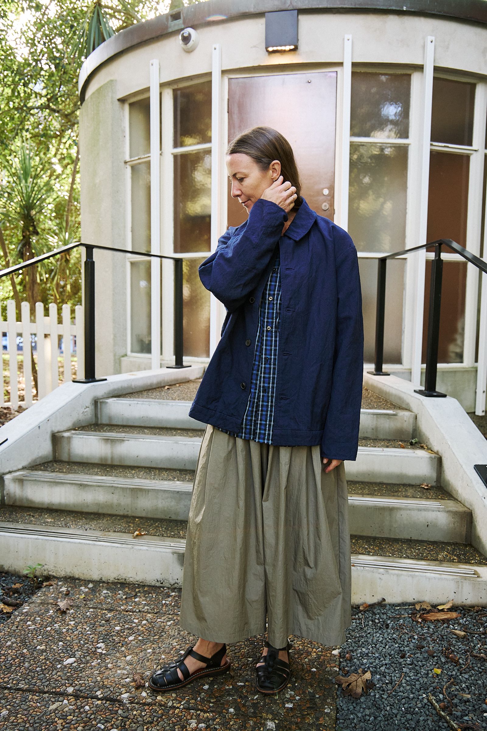 woman dressed in long skirt, check shirt and indigo jacket