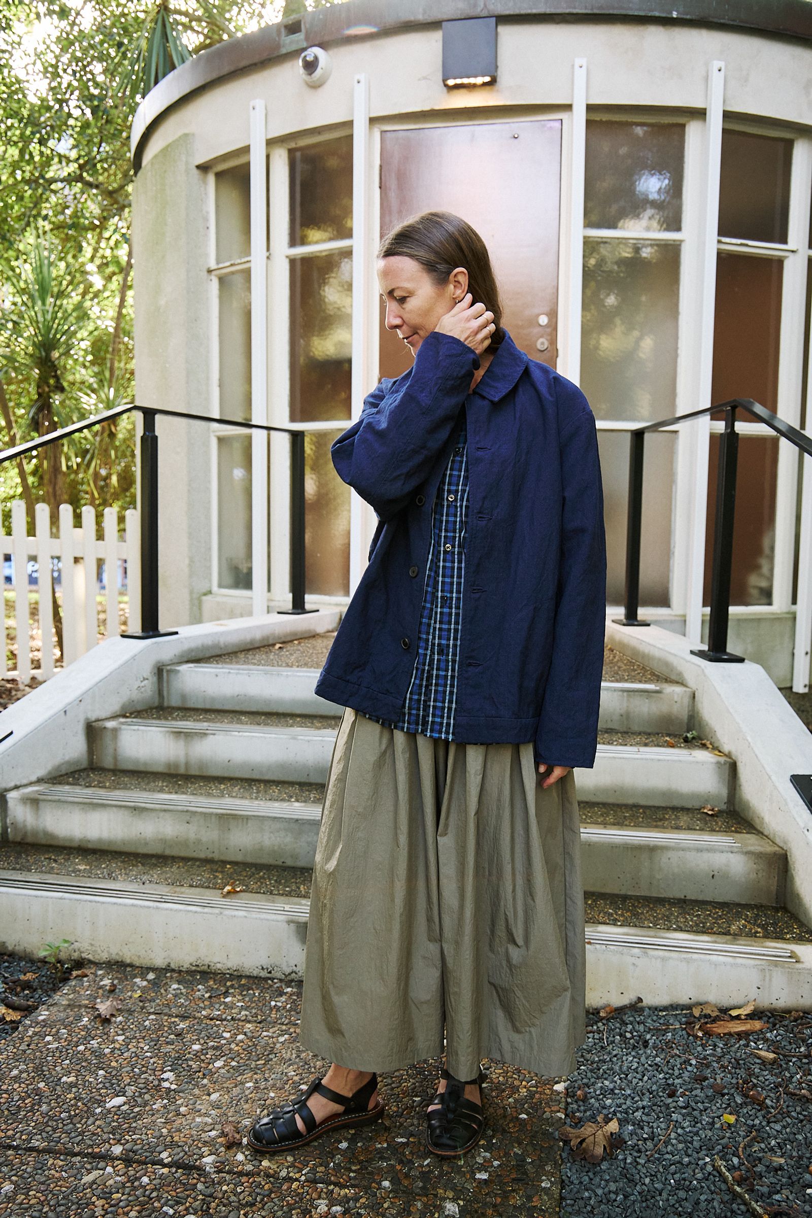 woman dressed in long skirt, check shirt and indigo jacket