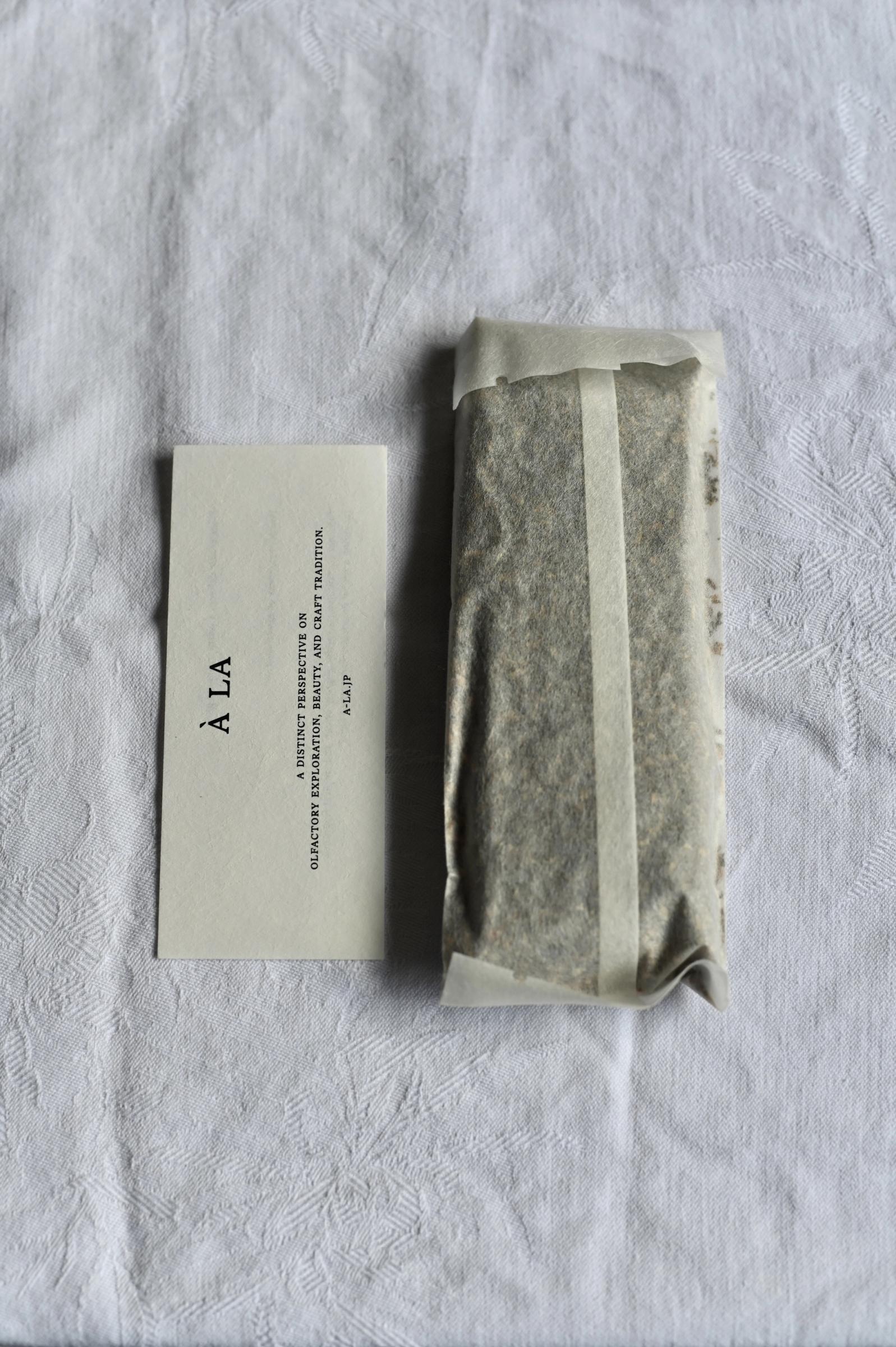 packaging of potpourri in white paper bag with brand card