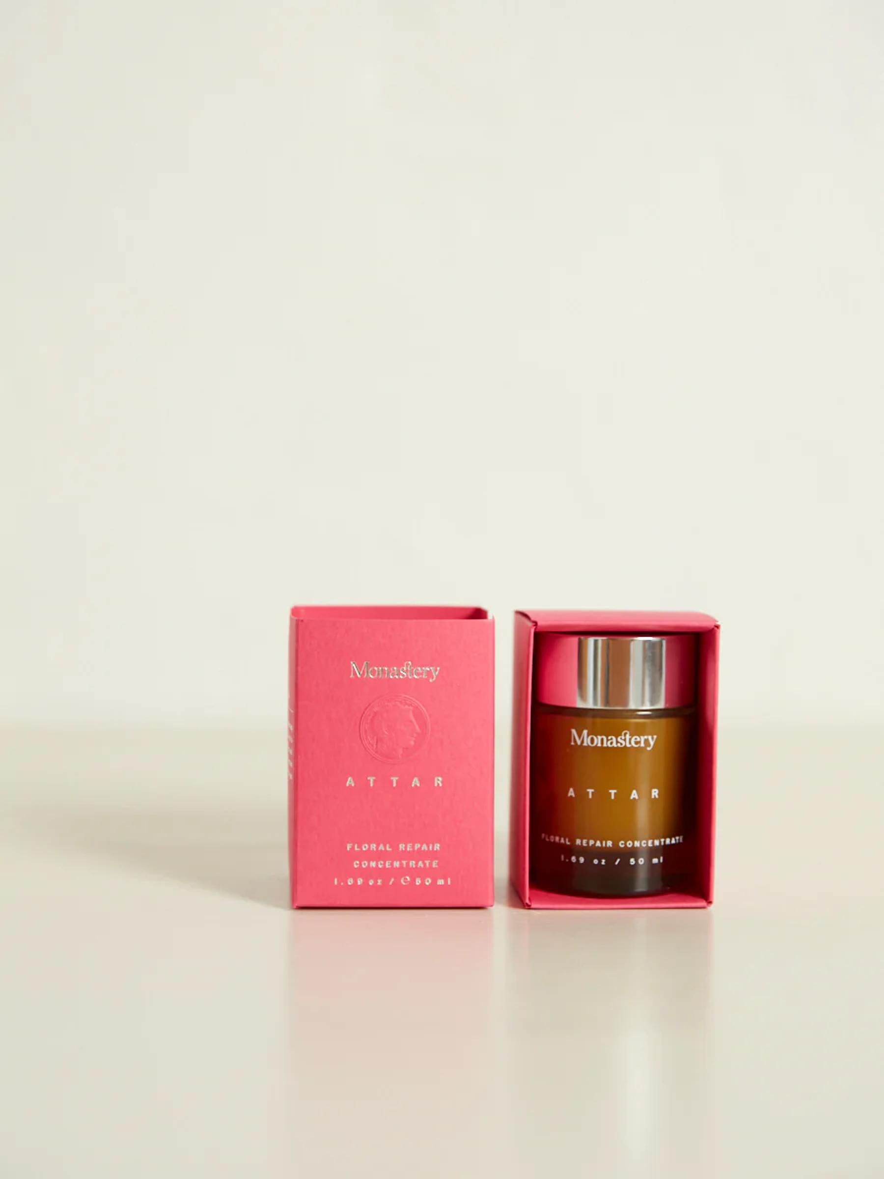 Monastery "Attar" skincare product. Pink box on left, brown glass bottle with silver cap on right. Label reads "Floral Repair Concentrate".