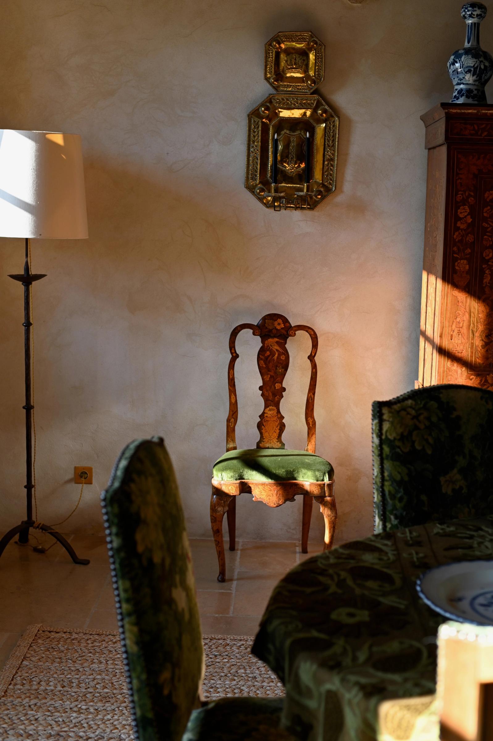 a wooden chair catches a ray of sunlight through the window