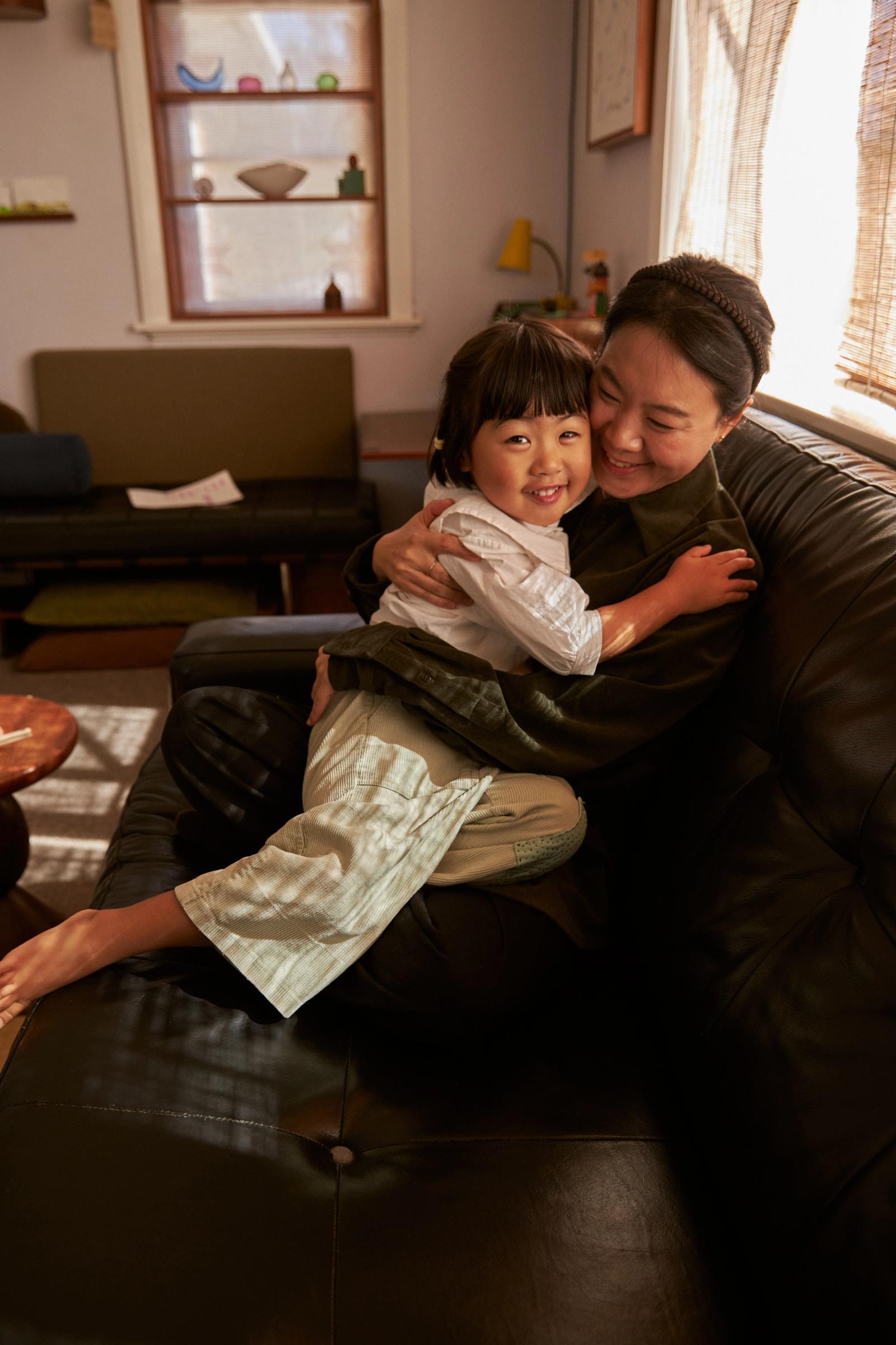 smiles and cuddles on the couch in the sunlight