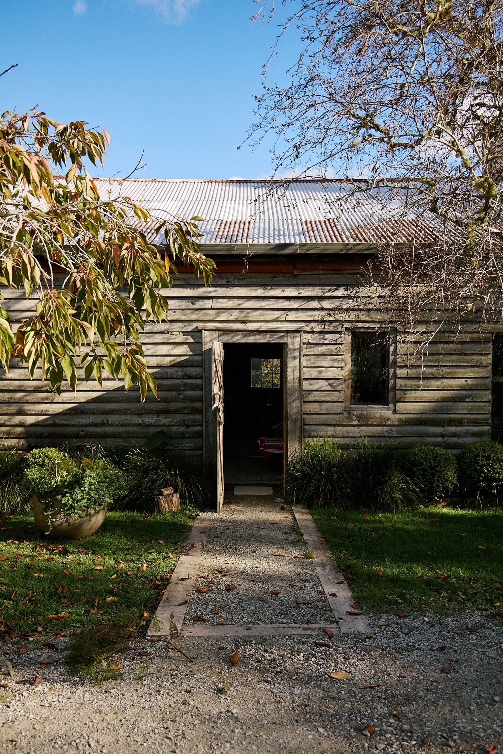 the flower barn clad in cedar wood and door flung open 