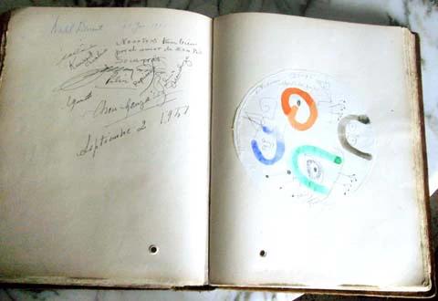 Weathered book with handwritten notes and abstract drawing. Dated September 2, 1957.