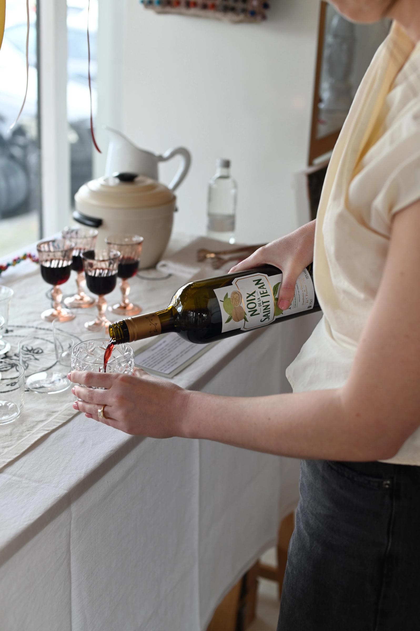 woman pouring a glass of wine into a glass