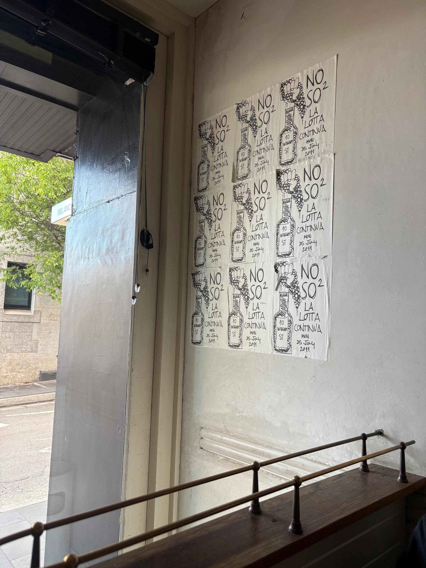 hand drawn posters on the wall of restaurant with view to the street