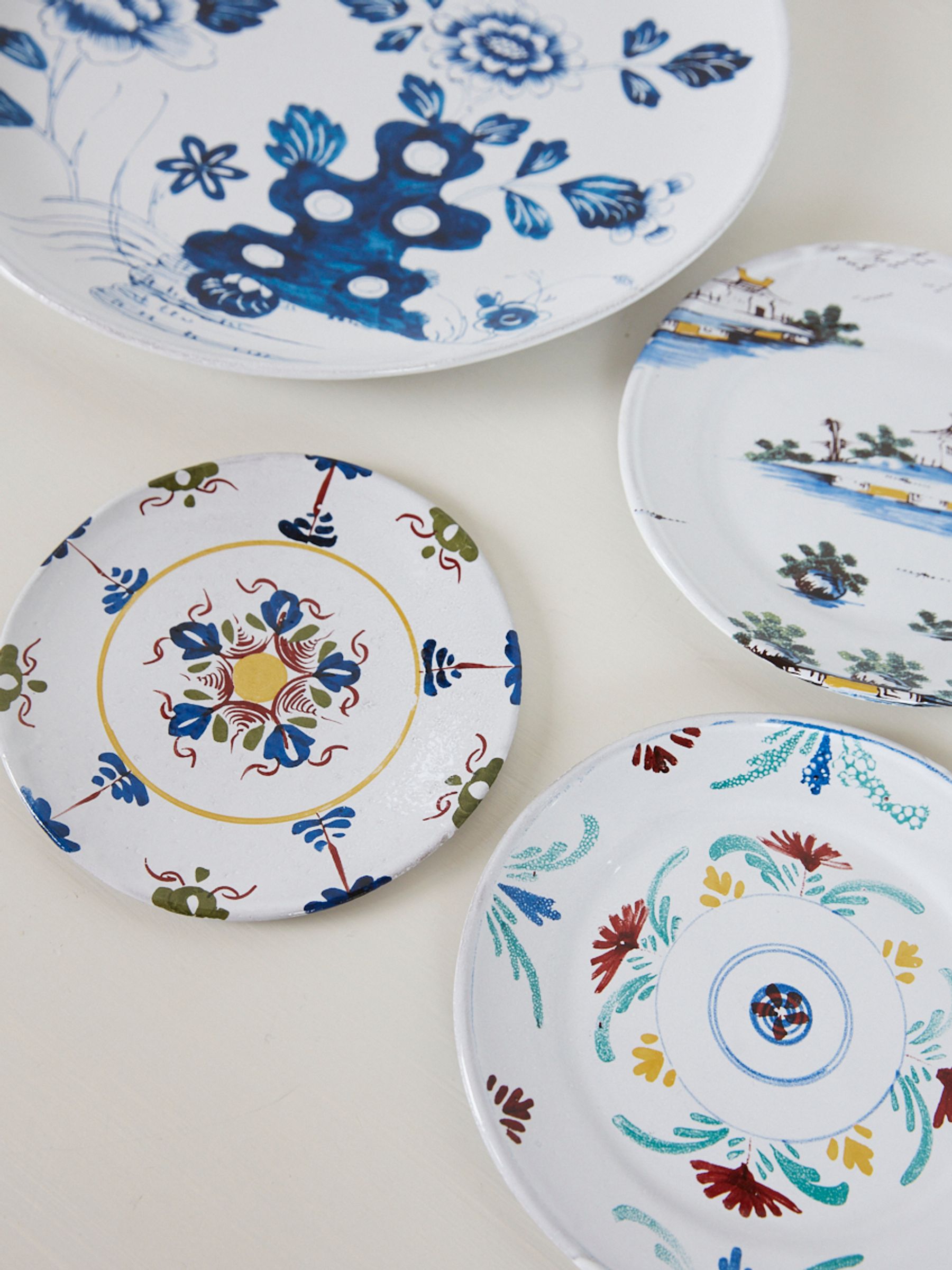 four bright hand painted plates