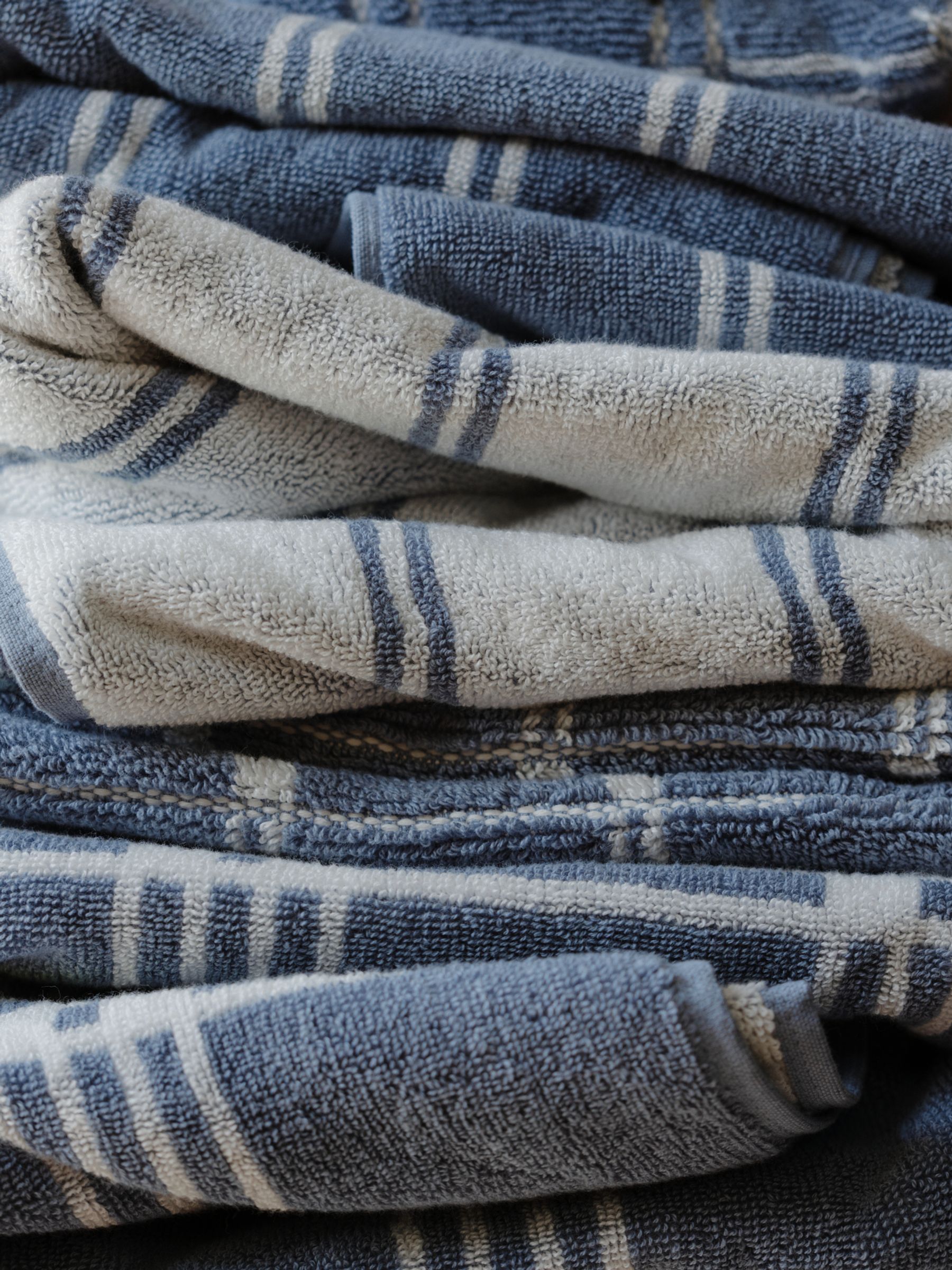 A stack of towels show the blue and cream check pattern 