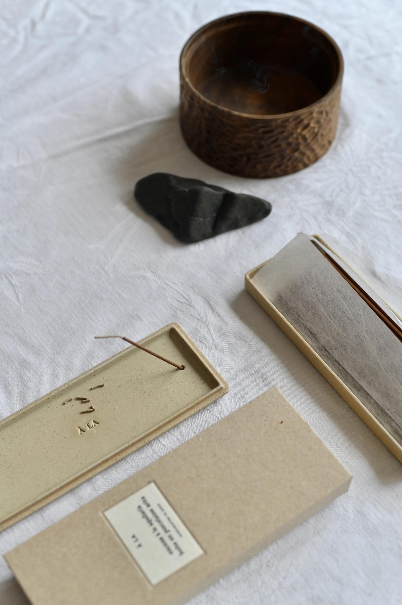 incense burning in a ceramic a la tray on the table