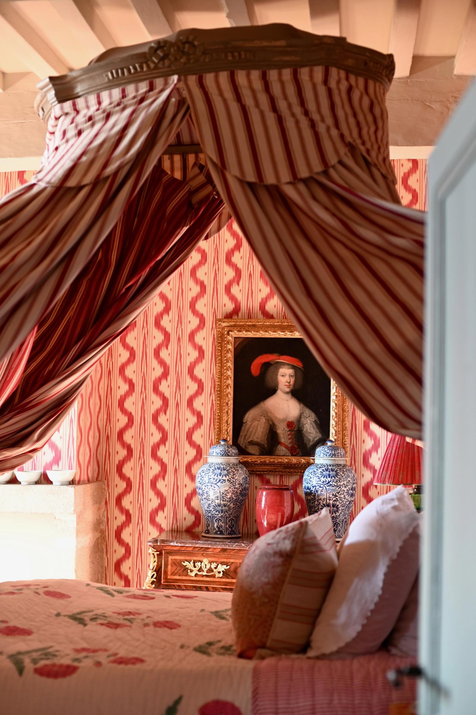 looking over the floral bed to a painting on the wall