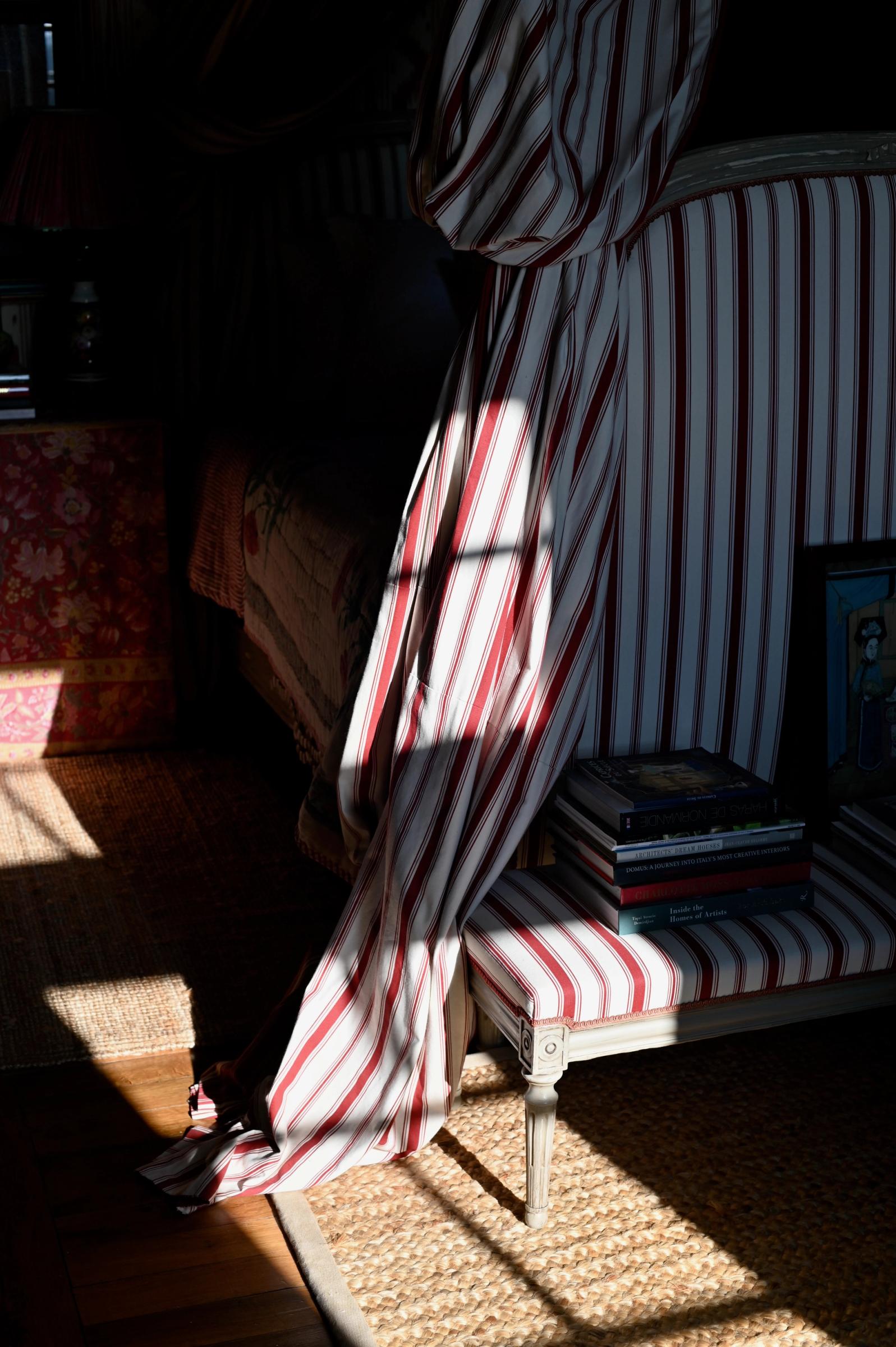 sunlight hitting the bed cover and textured rug