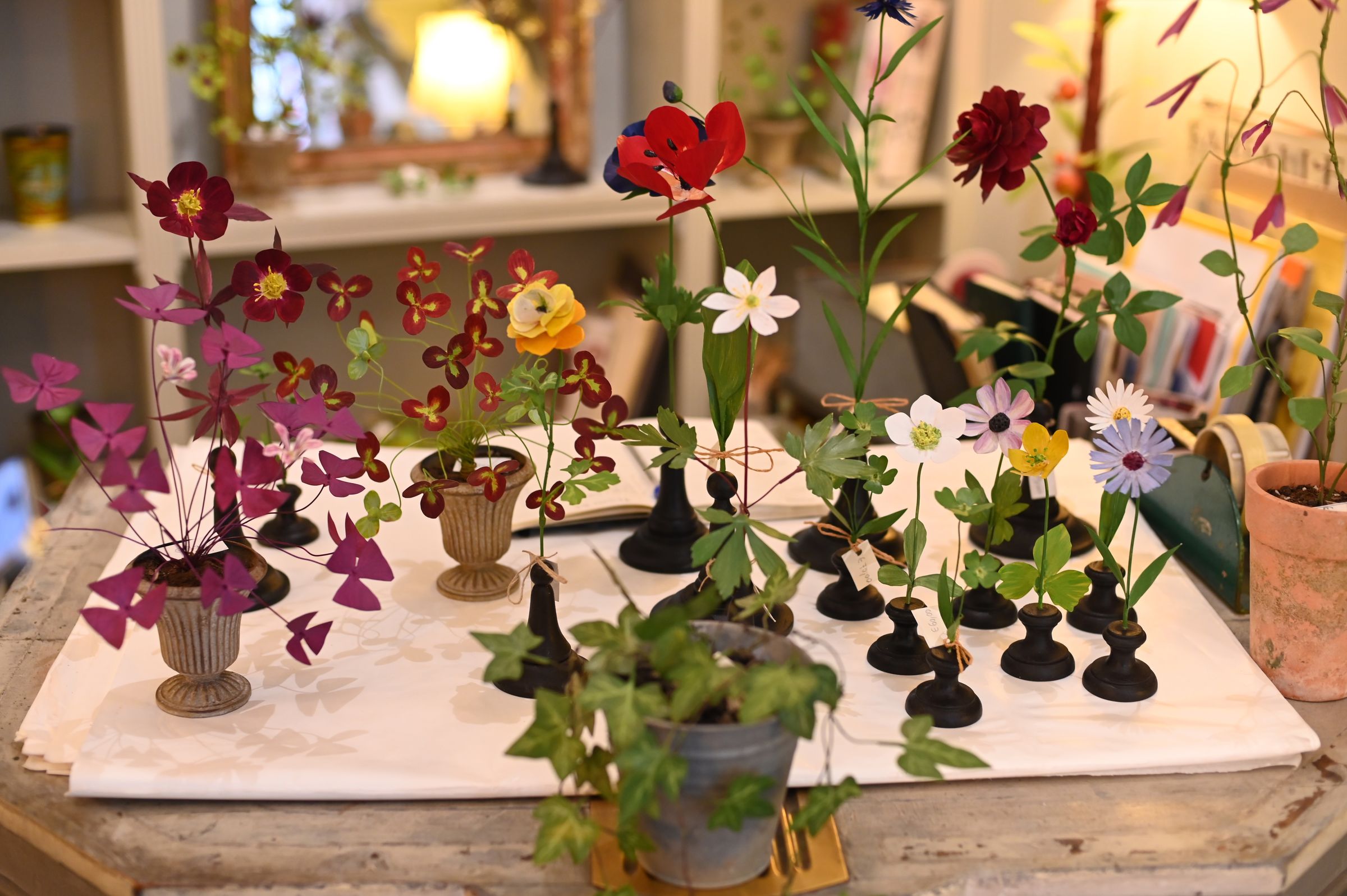 group of copper flower sculpture sitting on the counter in store