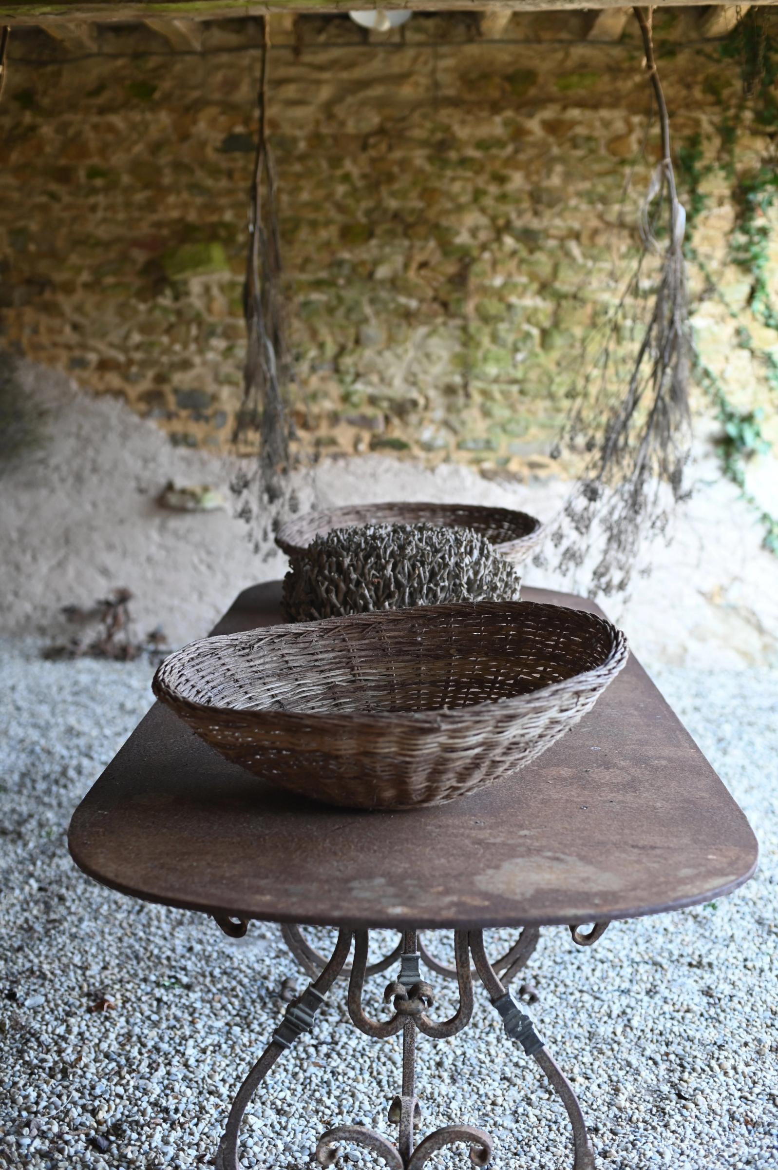 storage baskets for harvesting in the garden on a iron table outside